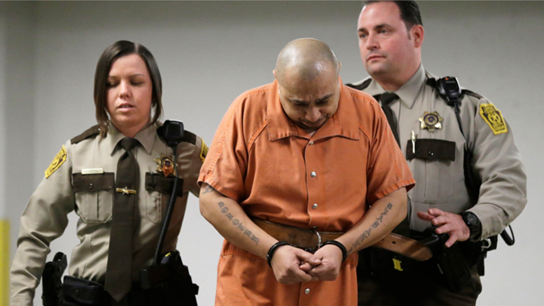 March 7, 2013: Julio Acevedo is escorted to a hearing at the Lehigh County Courthouse in Allentown, Pa. Acevedo was arrested in Pennsylvania on Wednesday after a friend arranged his surrender and was ordered held without bail. He is a suspect in a hit-and-run crash that killed a pregnant woman and her husband on their way to a hospital in New York. Their premature baby, delivered after the crash, later died.