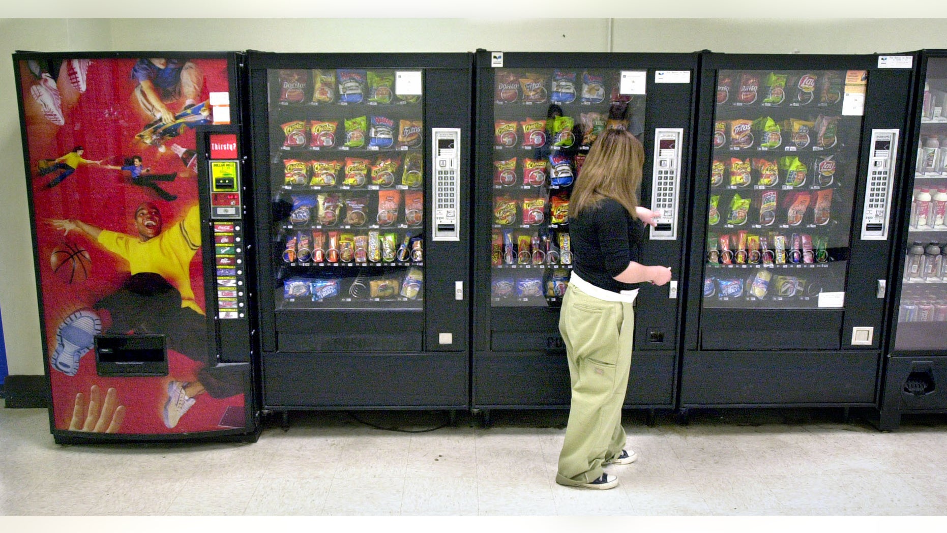 A student purchases a brown sugar Pop-Tart from a vending machine in the hallway outside the school cafeteria, in Wichita.