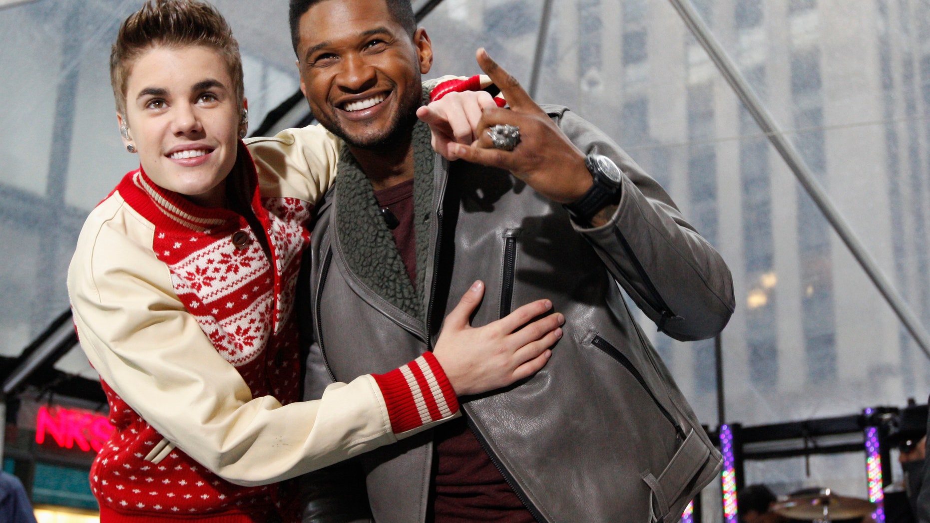 November 23, 2011. Singers Justin Bieber and Usher (R) pose together after performing on NBC's "Today" show in New York.