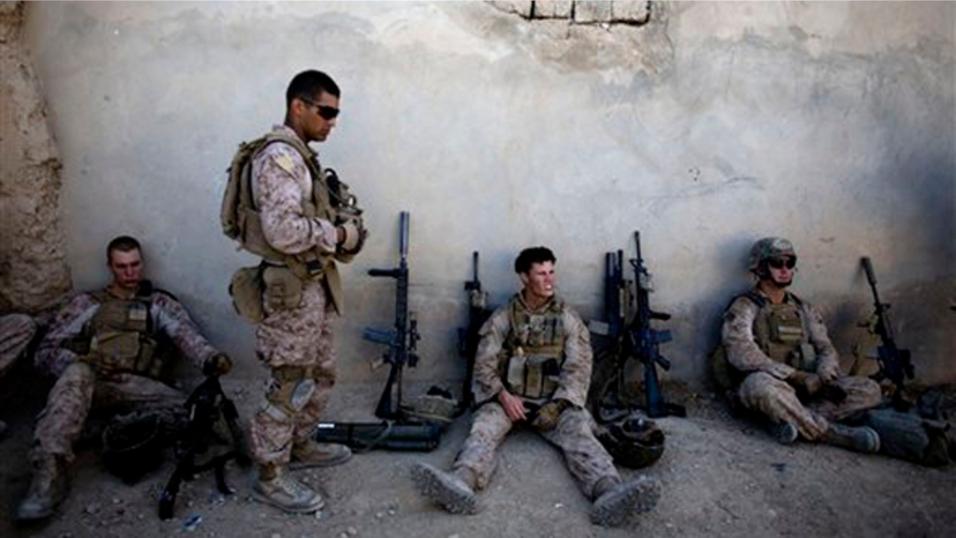 Marines with India company, 3rd Battalion 5th Marines, First Marine Division, take a break during a patrol in Sangin, south of Kabul, Afghanistan on Nov. 3. (AP Photo)