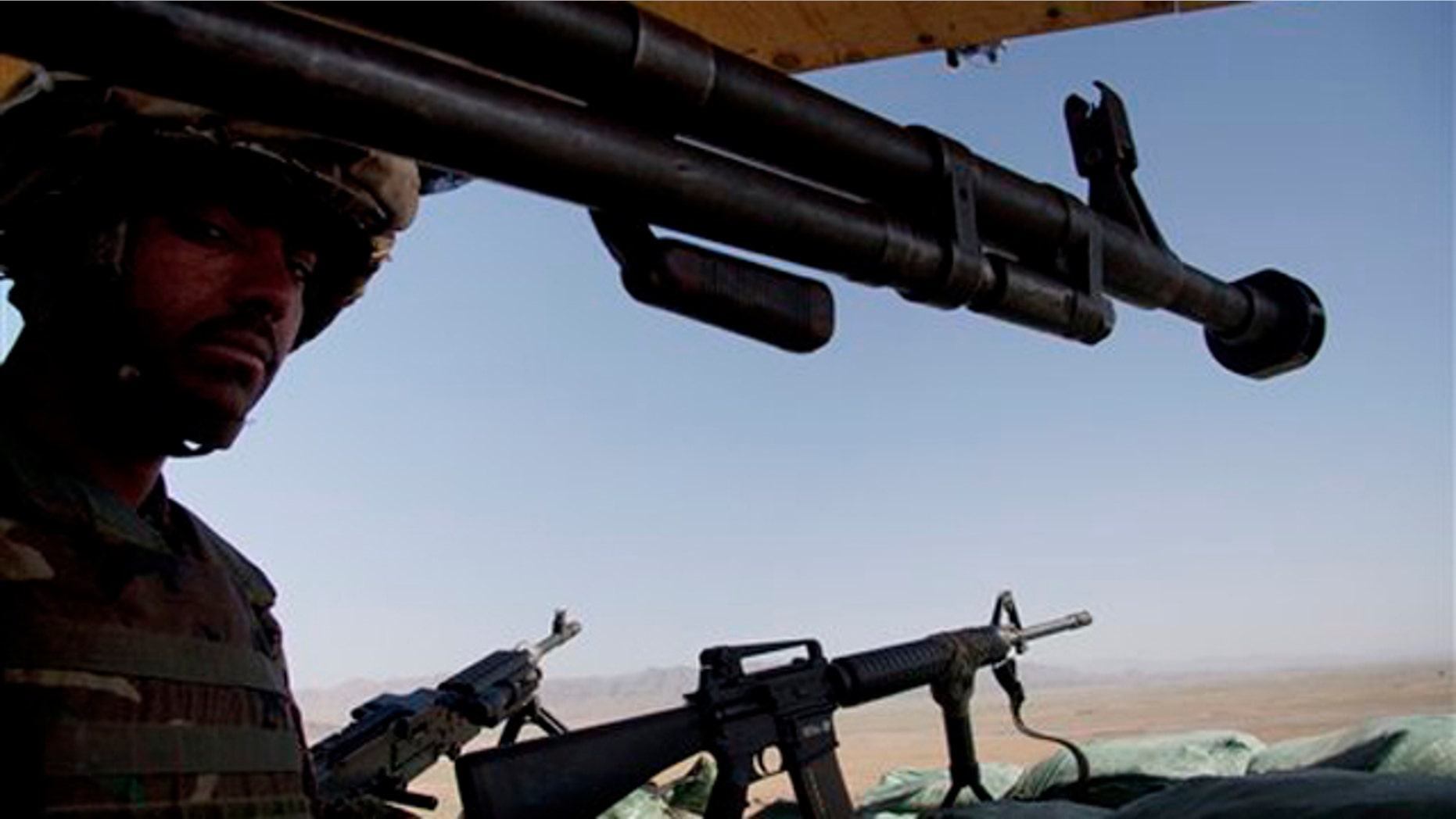 In this April 26 photo, a soldier of the Afghan National Army stands guard at a joint U.S. Marines observation post in Nawzad, Helmand province south of Kabul, Afghanistan.