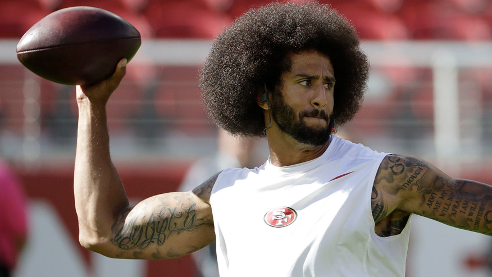 In this photo take Oct. 23, 2016, San Francisco 49ers quarterback Colin Kaepernick warms up before an NFL football game against the Tampa Bay Buccaneers in Santa Clara, Calif. In recent months, Kaepernick has become comfortable with people knowing him as more than a laser-focused football player as he always previously preferred it. Perhaps, through the anthem protest and his emergence as an outspoken activist for minorities, he has improved his image in the process. (AP Photo/Marcio Jose Sanchez)