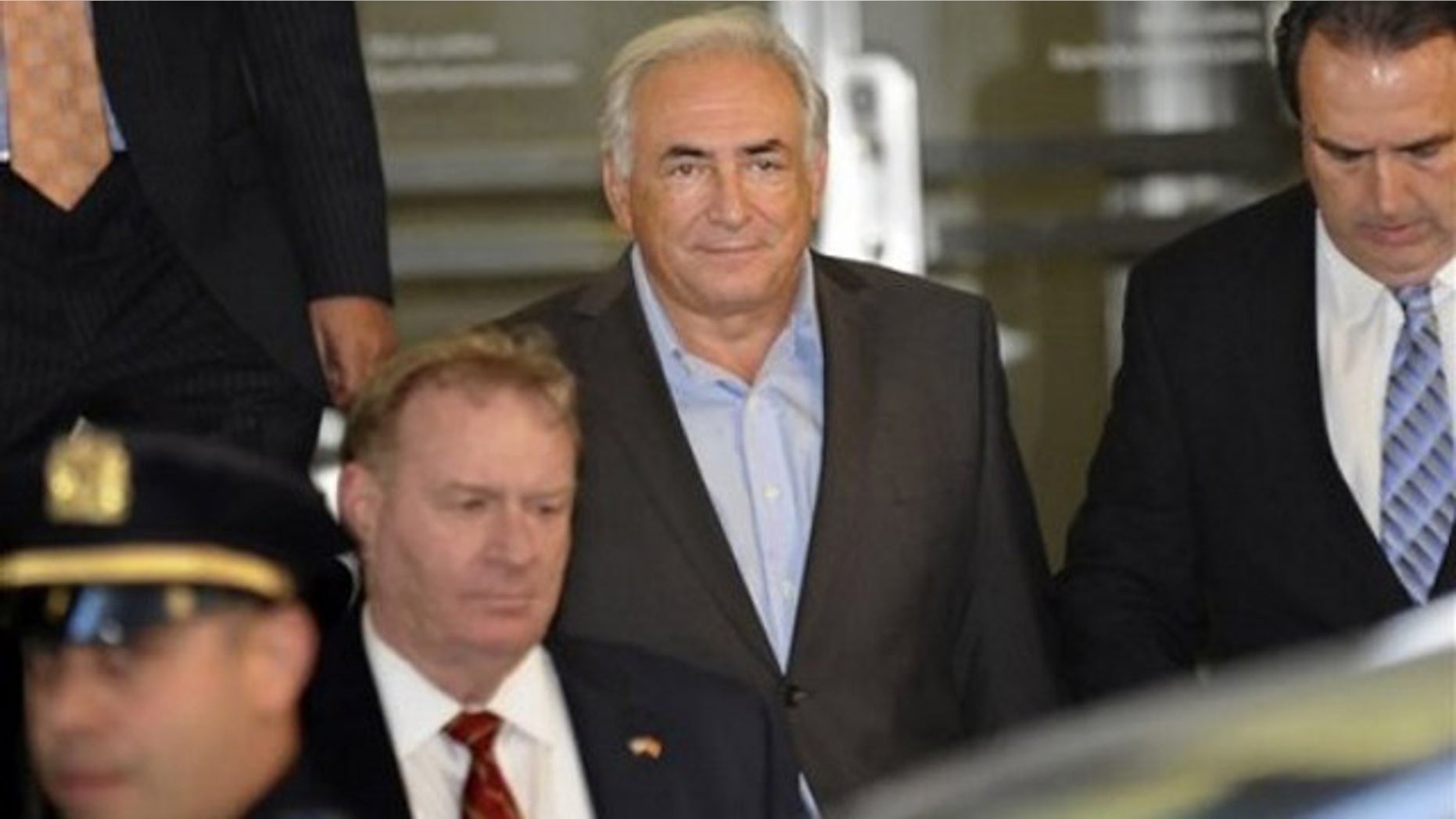 May 25: Dominique Strauss-Kahn, center, is led from 71 Broadway in Manhattan's financial district where the former International Monetary Fund leader was staying following his release on bail (AP).