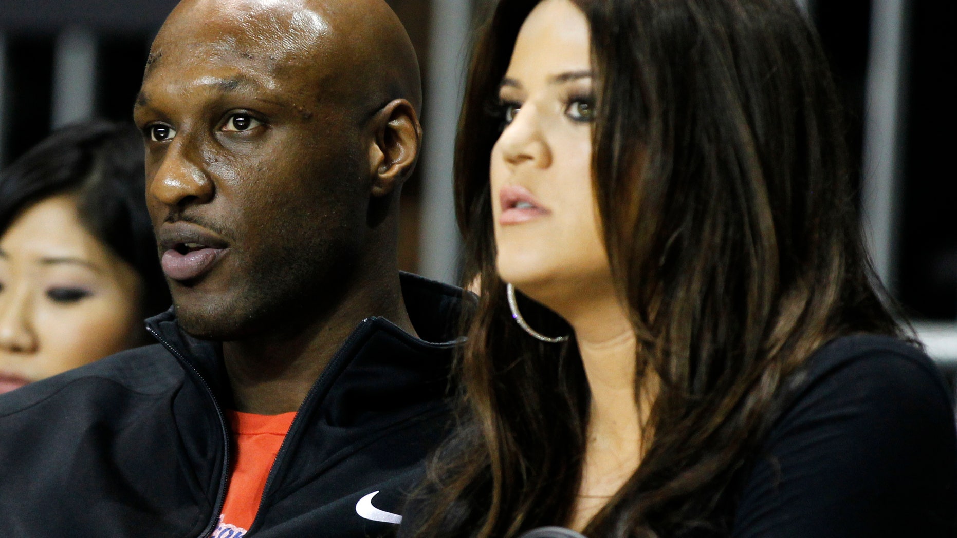 Los Angeles Lakers' Lamar Odom (L) and his wife television personality Khloe Kardashian sit courtside as they attend the 2011 BBVA All-Star Celebrity basketball game as a part of the NBA All-Star basketball weekend in Los Angeles, February 18, 2011. REUTERS/Danny Moloshok (UNITED STATES - Tags: SPORT BASKETBALL ENTERTAINMENT) - RTR2ISS6