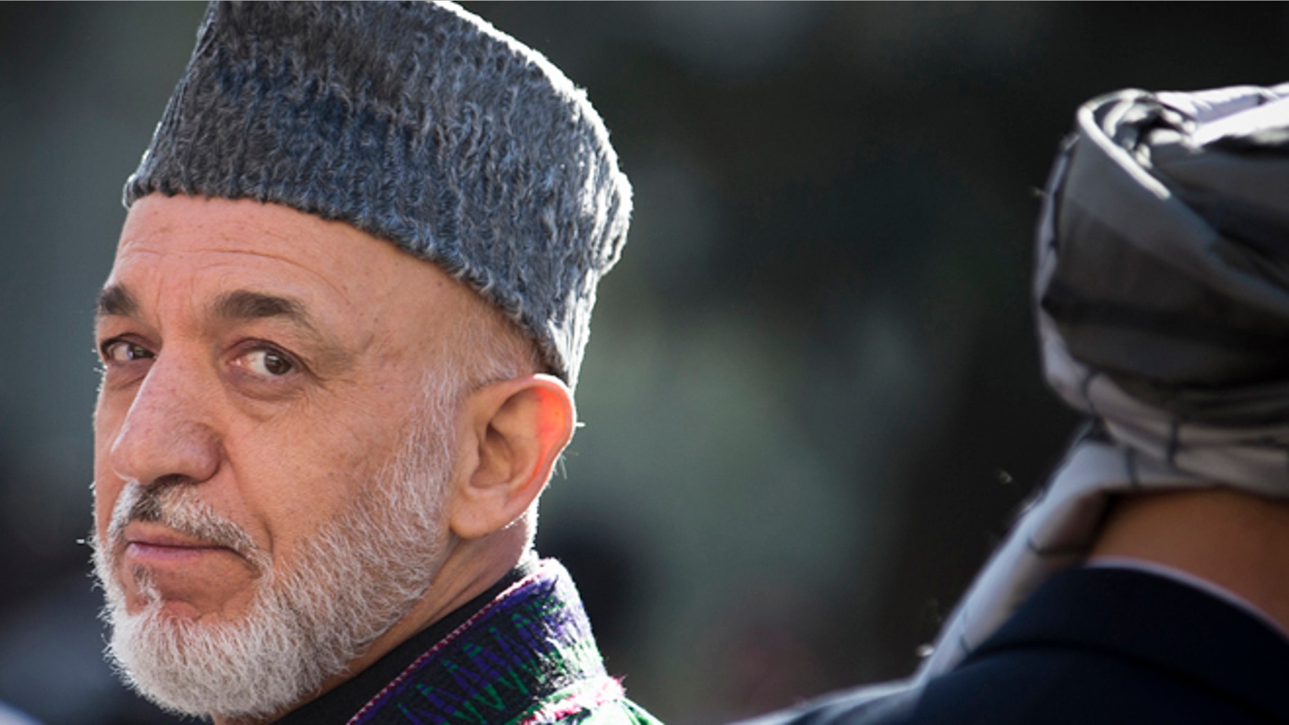 In this Friday, Oct 26, 2012 file photo, Afghan President Hamid Karzai turns around after reviewing the guard of honor during the first day of Eid Al Adha celebrations at the presidential palace in Kabul, Afghanistan. As the clock ticks toward 2014 and the final withdrawal of NATO and U.S. troops, peace talks with the Taliban are floundering even as the Taliban are showing some hopeful signs, attending international conferences and issuing a statement from their reclusive one-eyed leader with a surprise offer to share power in Afghanistan.