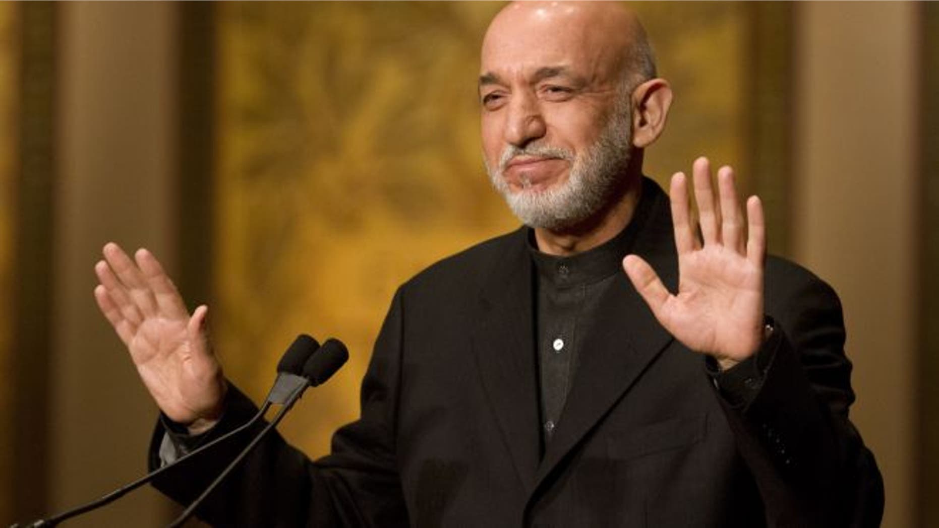 Jan. 11, 2013: Afghanistan President Hamid Karzai gestures for applause to stop before he began his speech at Georgetown University in Washington.