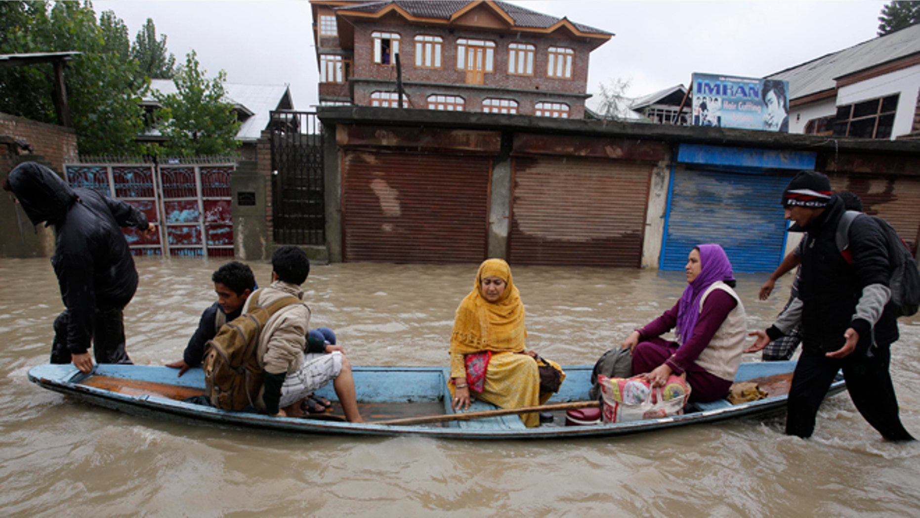 Sept. 4, 2014: Residents leave a flooded neighborhood on a boat in Srinagar, India. Authorities say heavy rains have triggered floods and landslides in the Indian portion of Kashmir, killing at least 14 people in the worst flooding in 22 years.