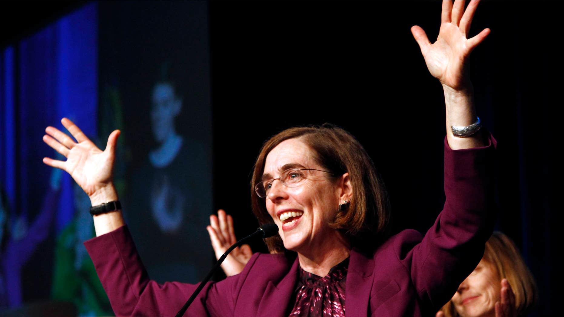 Nov. 6, 2012: Oregon Democratic Secretary of State Kate Brown celebrates at the podium after winning her race at Democratic headquarters.