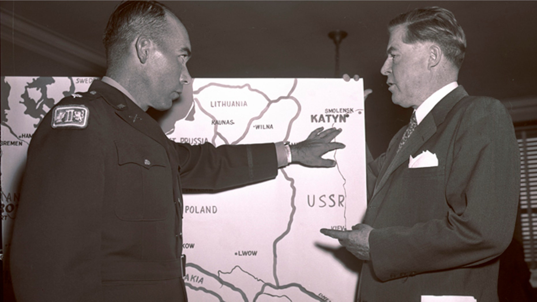 In this Oct. 11, 1951 file photo, Lt. Col. Donald B. Stewart, left, locates the site of a mass grave near near Smolensk, Russia, to Rep. Ray Madden, D-Ind., during a special House Committee hearing in Washington. Stewart and Lt. Col. John H. Van Vliet Jr., were among a group of British and American prisoners forced by the Germans to see a horrifying site, a mass grave where murdered Polish officers were buried, near Smolensk.