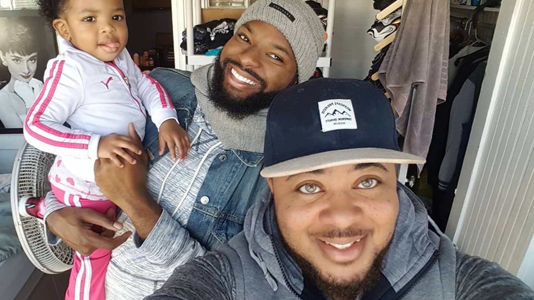 Kayden Coleman, 29 (front), with his husband, Elijah, 27, and their daughter, Azaelia.