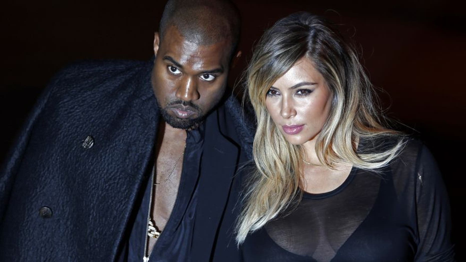 U.S. musician Kanye West and companion Kim Kardashian arrive at the Givenchy Spring/Summer 2014 women's ready-to-wear fashion show during Paris Fashion Week September 29, 2013