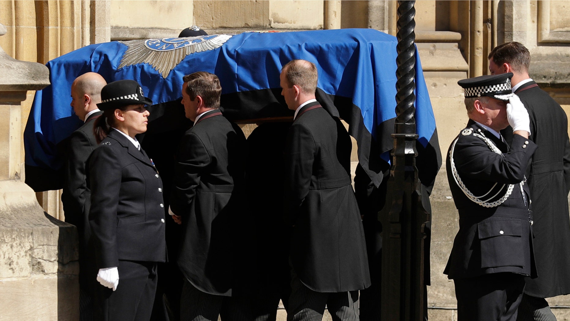 Pallbearers carrying the coffin of late police constable Keith Palmer, who was killed in the London attack on March 22, is carried into the Houses of Parliament to rest overnight in the Chapel of St Mary Undercroft, in London, Sunday, April 9, 2017. Palmer's funeral is due to take place at Southwark Cathedral in London on Monday. (AP Photo/Matt Dunham)