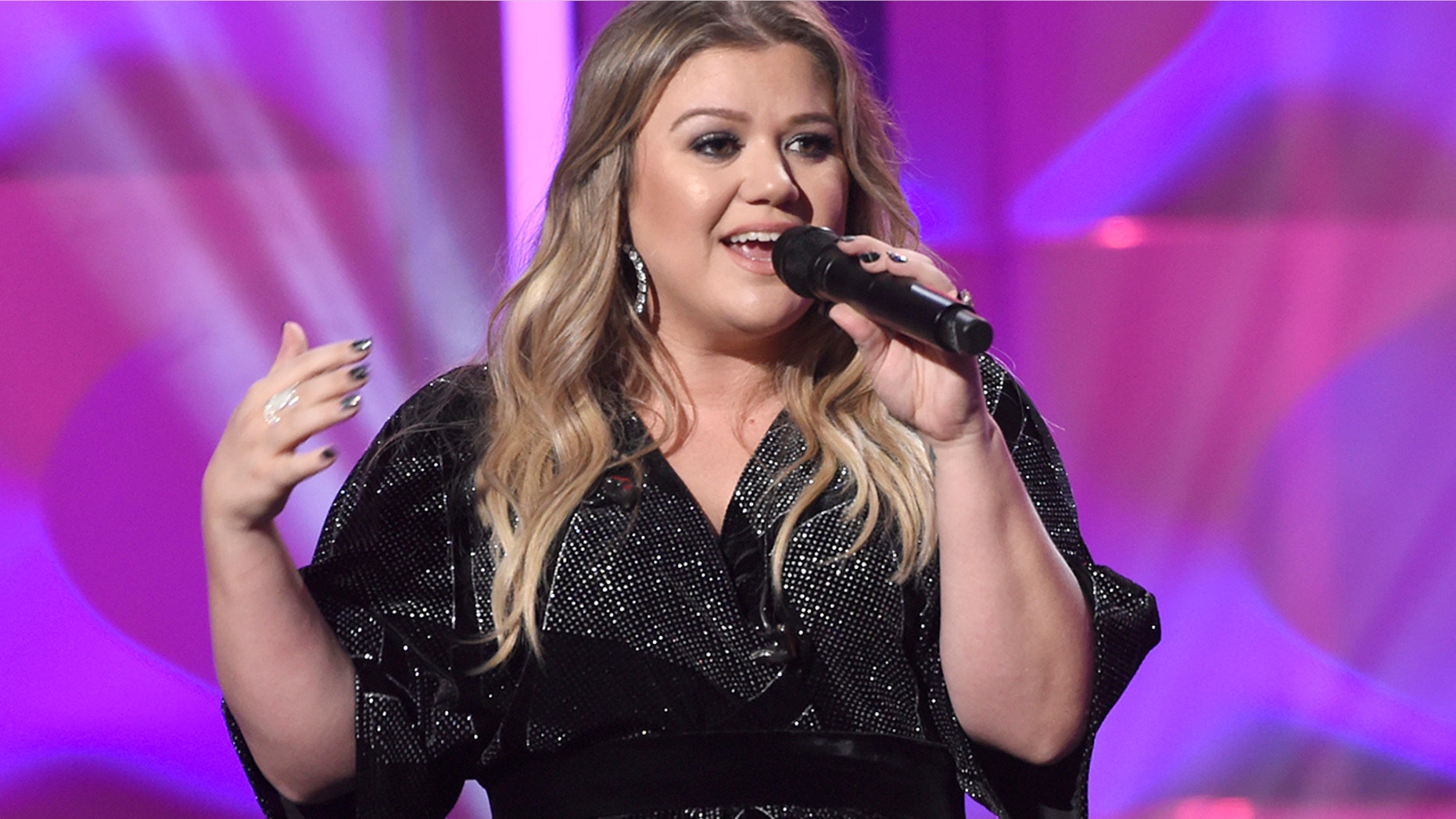 Kelly Clarkson accepts the powerhouse award at the Billboard Women in Music event at the Ray Dolby Ballroom on Thursday, Nov. 30, 2017, in Los Angeles.