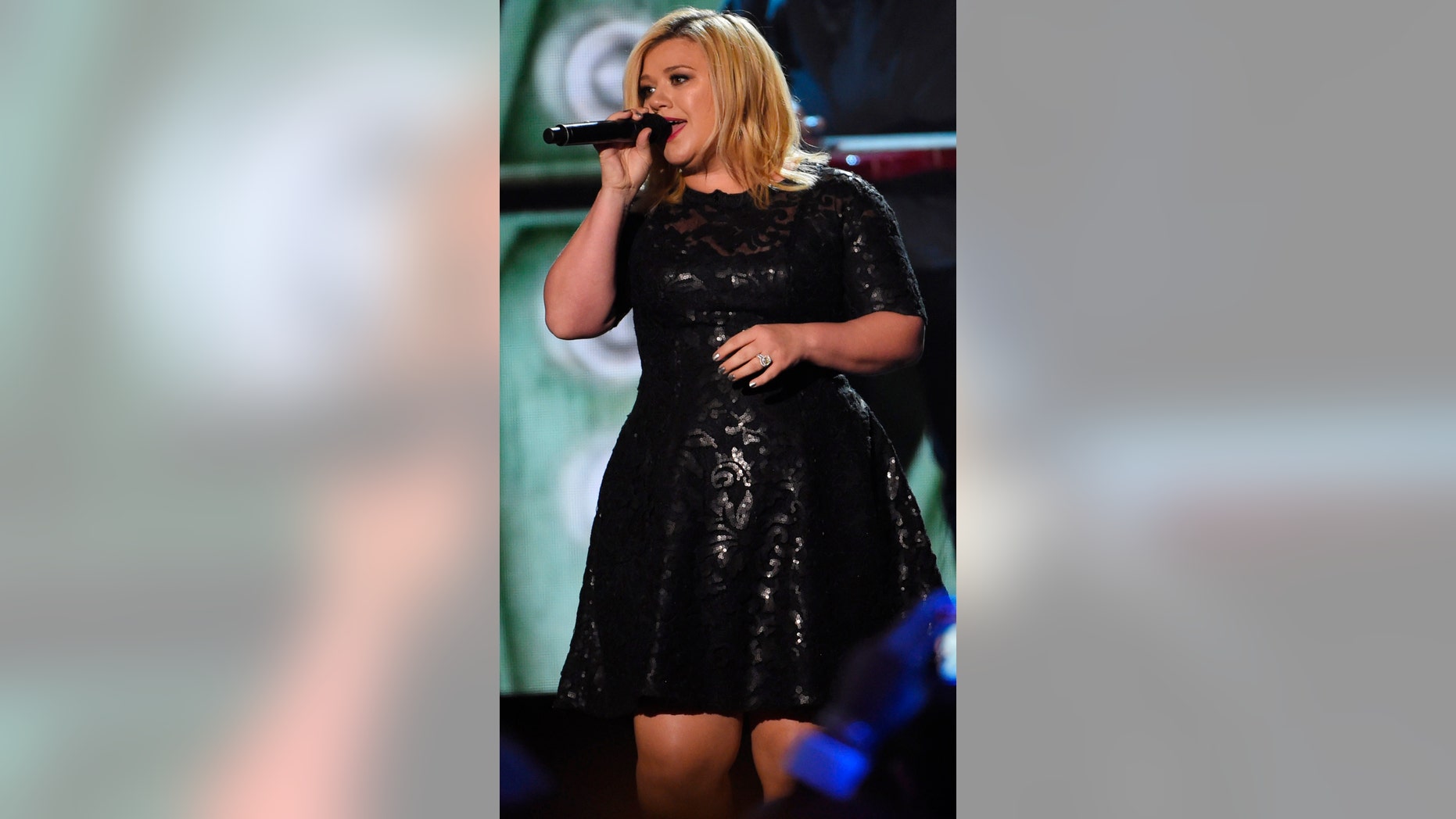 Kelly Clarkson performs "How Blue" as a tribute to Reba McEntire, the recipient of the first NASH Icon Award, during the American Country Countdown Awards in Nashville, Tennessee December 15, 2014.