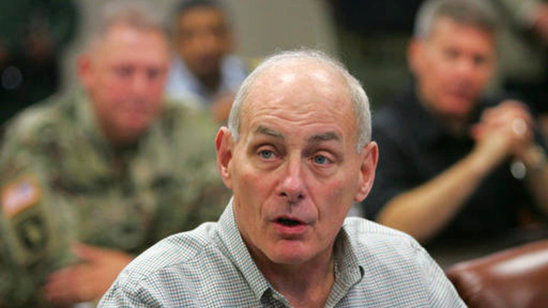 Secretary of Homeland Security John Kelly talks with Texas Governor Greg Abbott and other state law enforcement officials before a briefing on border security Wednesday Feb. 1, 2017 at the Texas Department of Public Safety regional headquarters in Weslaco, Texas. Secretary Kelly and Abbott toured the Texas border with Mexico in a helicopter following the briefing. (Nathan Lambrecht/The Monitor via AP, Pool)