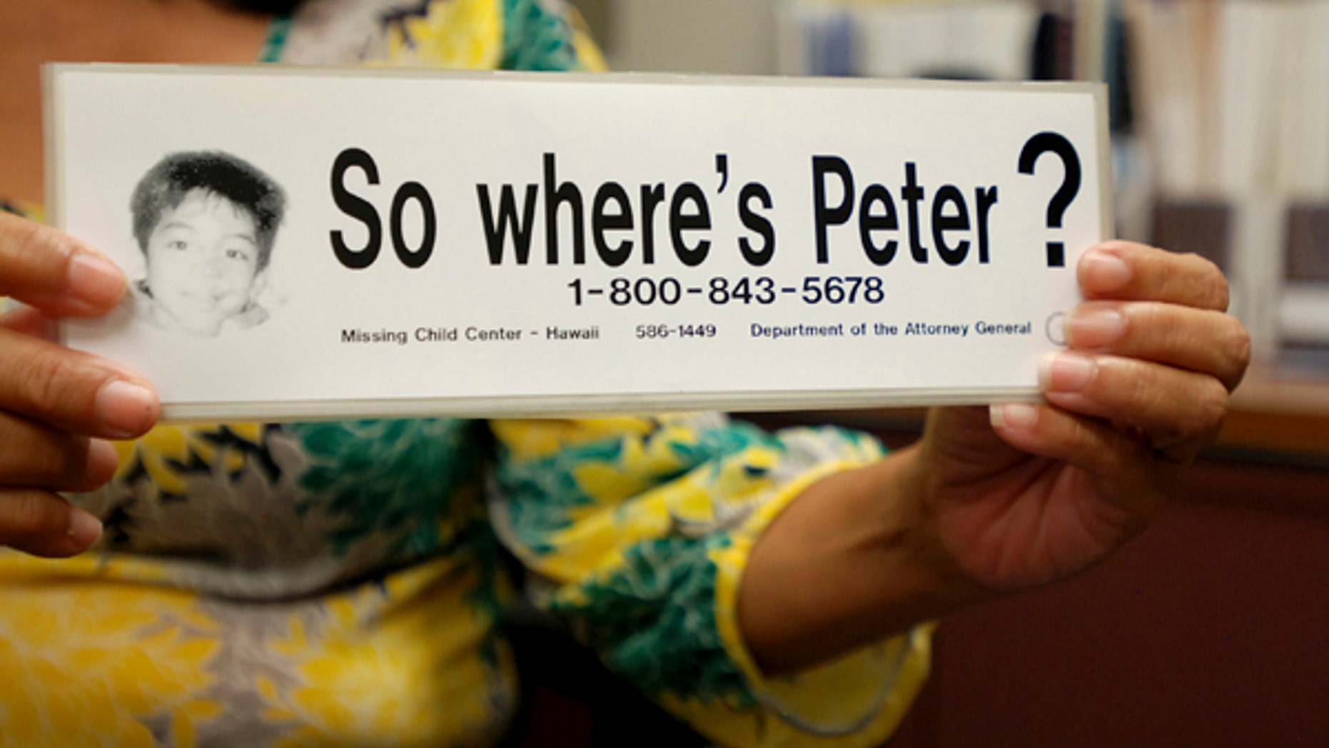 File - This June 6, 2016 file photo taken in Honolulu shows a bumper sticker Hawaii officials distributed in a campaign for a Hawaii boy who disappeared 20 years ago. The child, known as "Peter Boy," became the face of missing and abused children in the late 1990s and early 2000s. The father of a Hawaii boy who went missing 20 years ago has led police to the site Sunday, April 23, 2017, where he disposed his son's remains. Peter Kema Sr. is providing information about the location of the boy's body as part of a plea deal reached earlier this month. (AP Photo/Jennifer Sinco Kelleher, File)