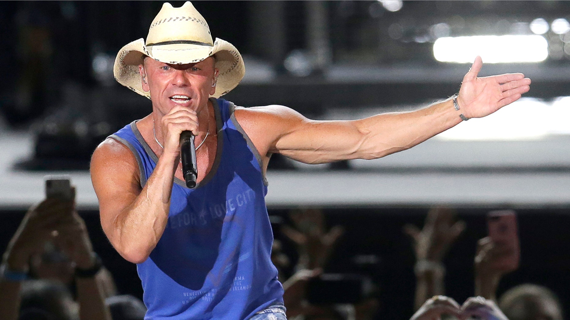In this June 23, 2018 file photo, Kenny Chesney performs during the Trip Around the Sun Tour in Phoenix. After Hurricane Irma decimated the U.S. Virgin Islands last year, country superstar Kenny Chesney started writing songs and organizing relief efforts. Chesney is donating proceeds from the sale of his new album, “Songs for the Saints,” to a foundation he set up to support recovery on the islands.