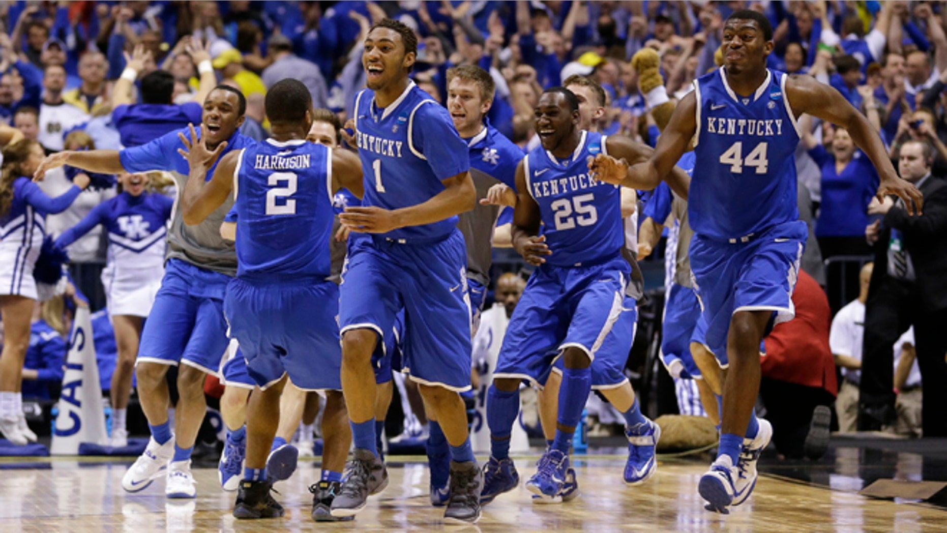 March 30, 2014: Kentucky players celebrate after an NCAA Midwest Regional final college basketball tournament game against Michigan to advance to the Final Four.