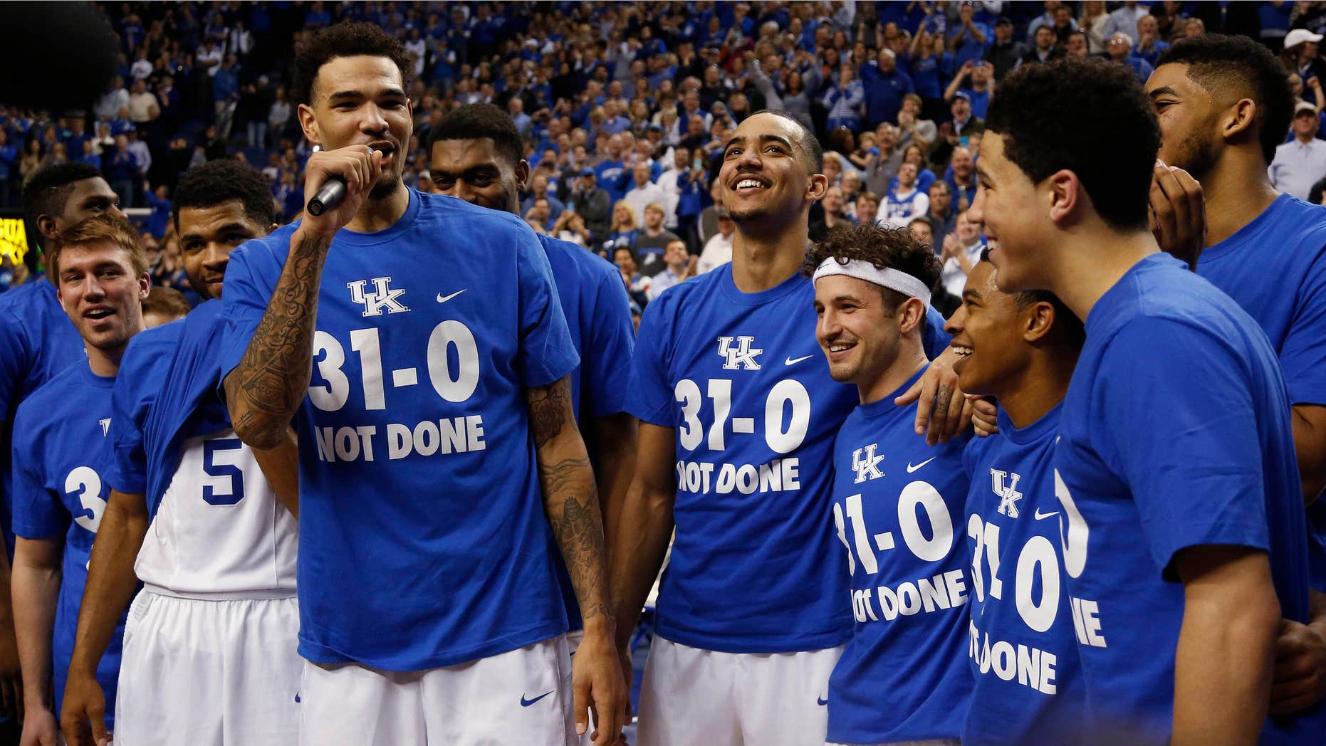 March 7, 2015: Kentucky's Willie Cauley-Stein, third from left, address the crowd during a ceremony marking the teams undefeated season after an NCAA college basketball game.