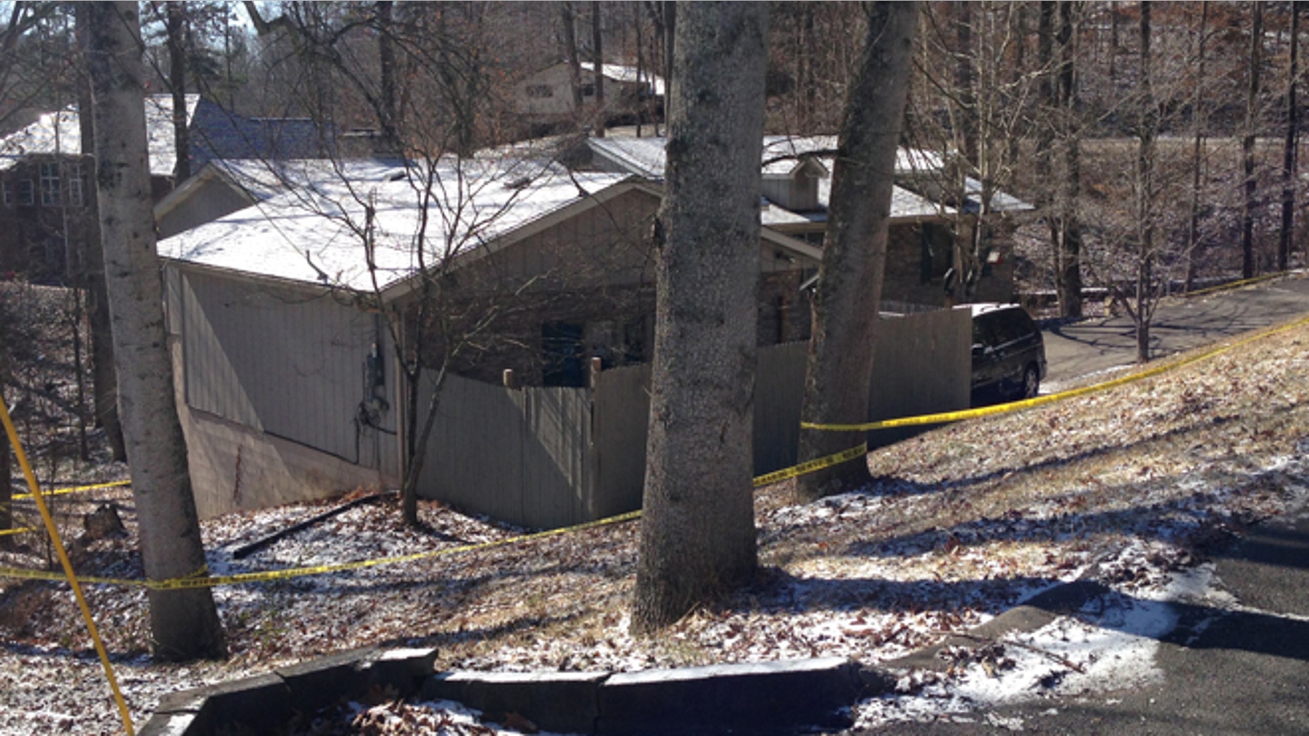 Feb. 15, 2015: Yellow tape surrounds a home in southeast Kentucky where a family was found dead. A couple and a young girl were reportedly found dead in the home on Saturday. Police are investigating to see if the case is connected to the shooting death of a young man in Baltimore on Saturday.