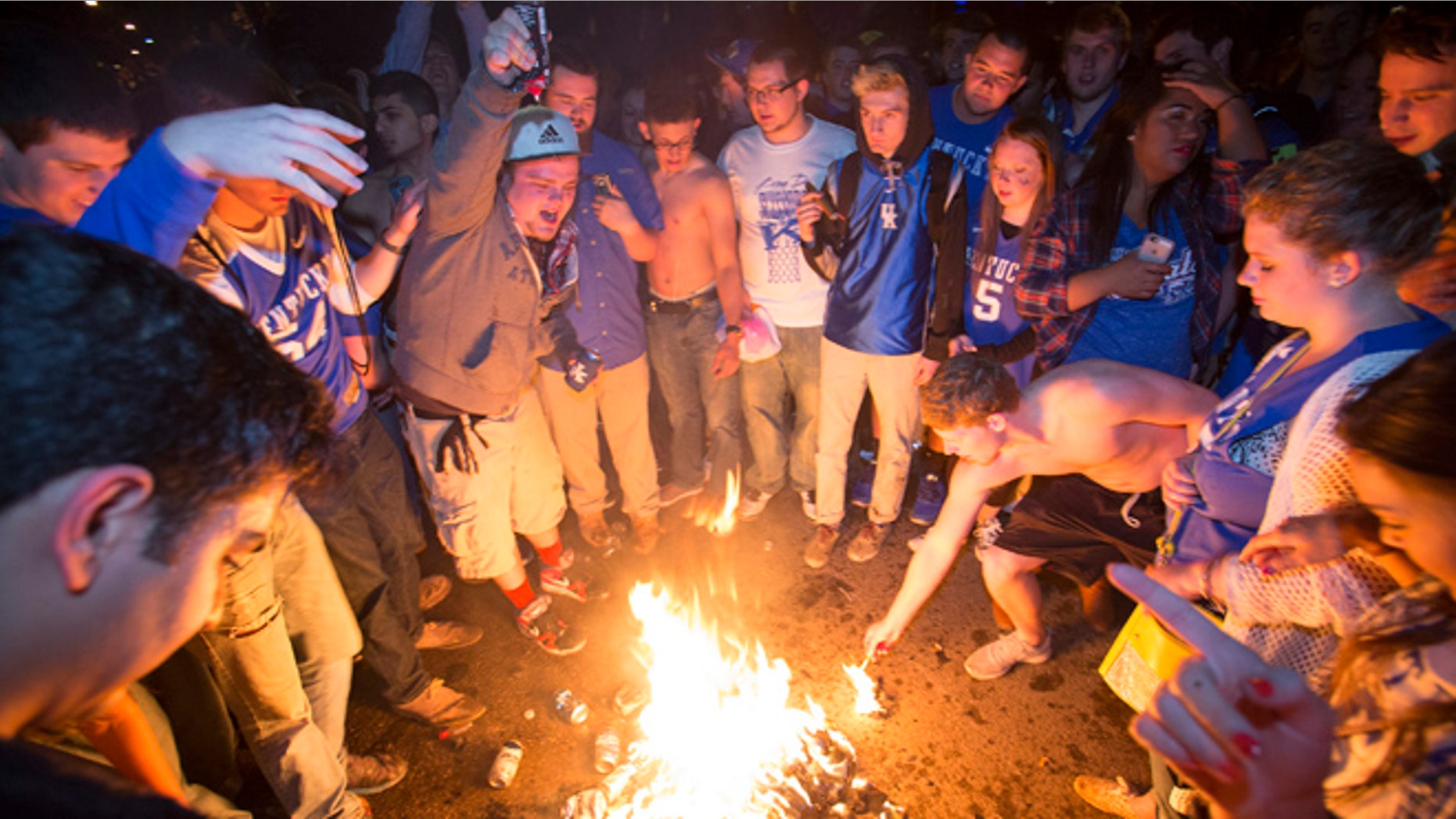 April 4, 2015: Kentucky fans set fire to shirts and hoodies as they gather near the University of Kentucky campus, in Lexington, Ky., after Wisconsin defeated Kentucky 71-64 in the semifinals of the NCAA men's college basketball tournament Final Four.