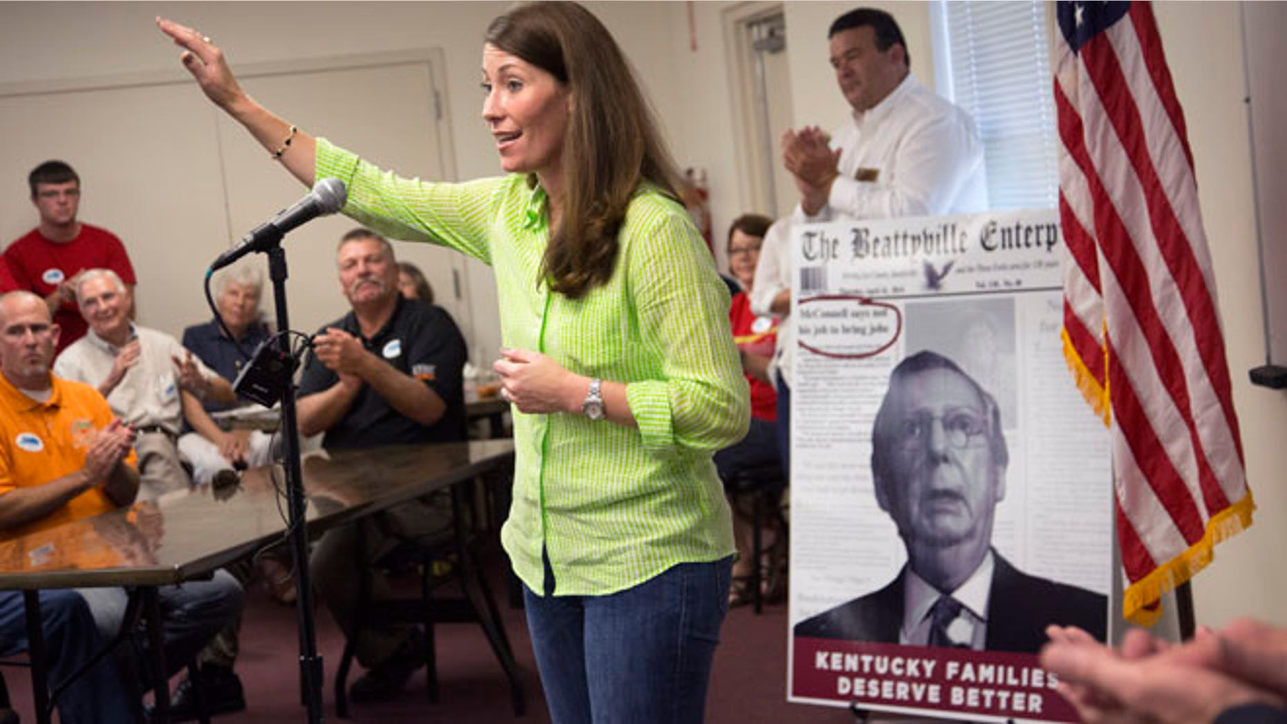 July 30, 2014: U.S. Senate candidate and Kentucky Secretary of State Alison Lundergan Grimes (D-KY), speaks to supporters in Hawesville, Ky., as a poster of her rival Senate Minority Leader Mitch McConnell of Ky., serves as a backdrop. (AP)