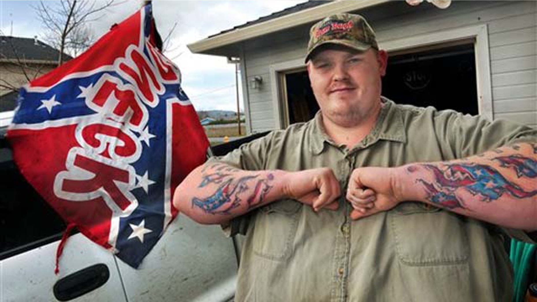 This Wednesday, March 2, 2011 picture shows Ken Webber, 28, a school bus driver from Medford, Ore. who was suspended from his job for refusing to remove a Confederate flag from the truck bed of his personal vehicle parked at the Phoenix-Talent School Districts bus barn on Colver Road in Talent, Ore. A spokeswoman for the school bus company said Webber was asked to remove the flag because it violates school district policy. Webber said his suspension violates his free speech rights and he plans to hire an attorney.