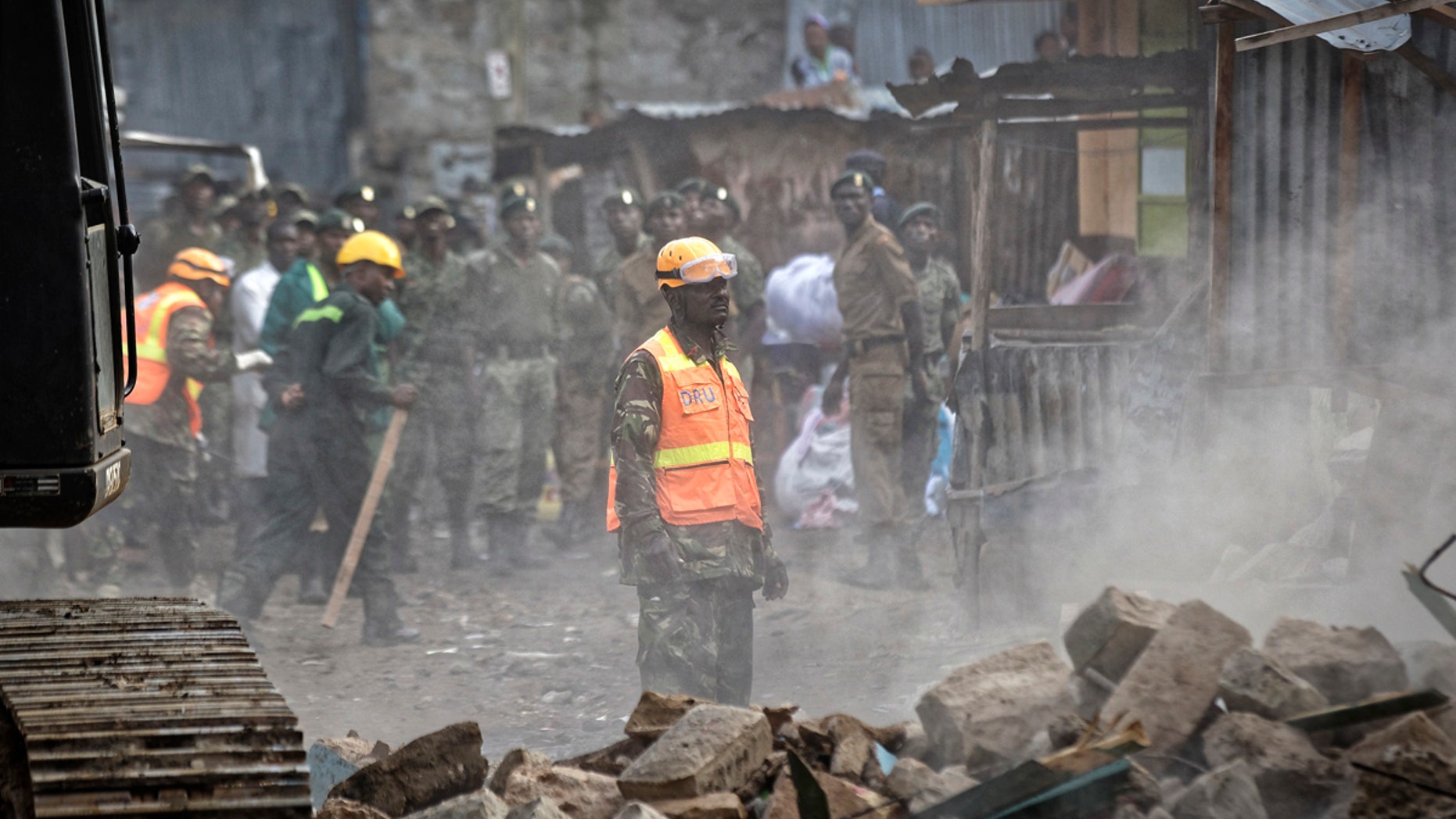 A rescuer aided by a heavy digger attends the scene of a five-storey collapsed building in the Huruma neighborhood of Nairobi, Kenya, June 3, 2018.
