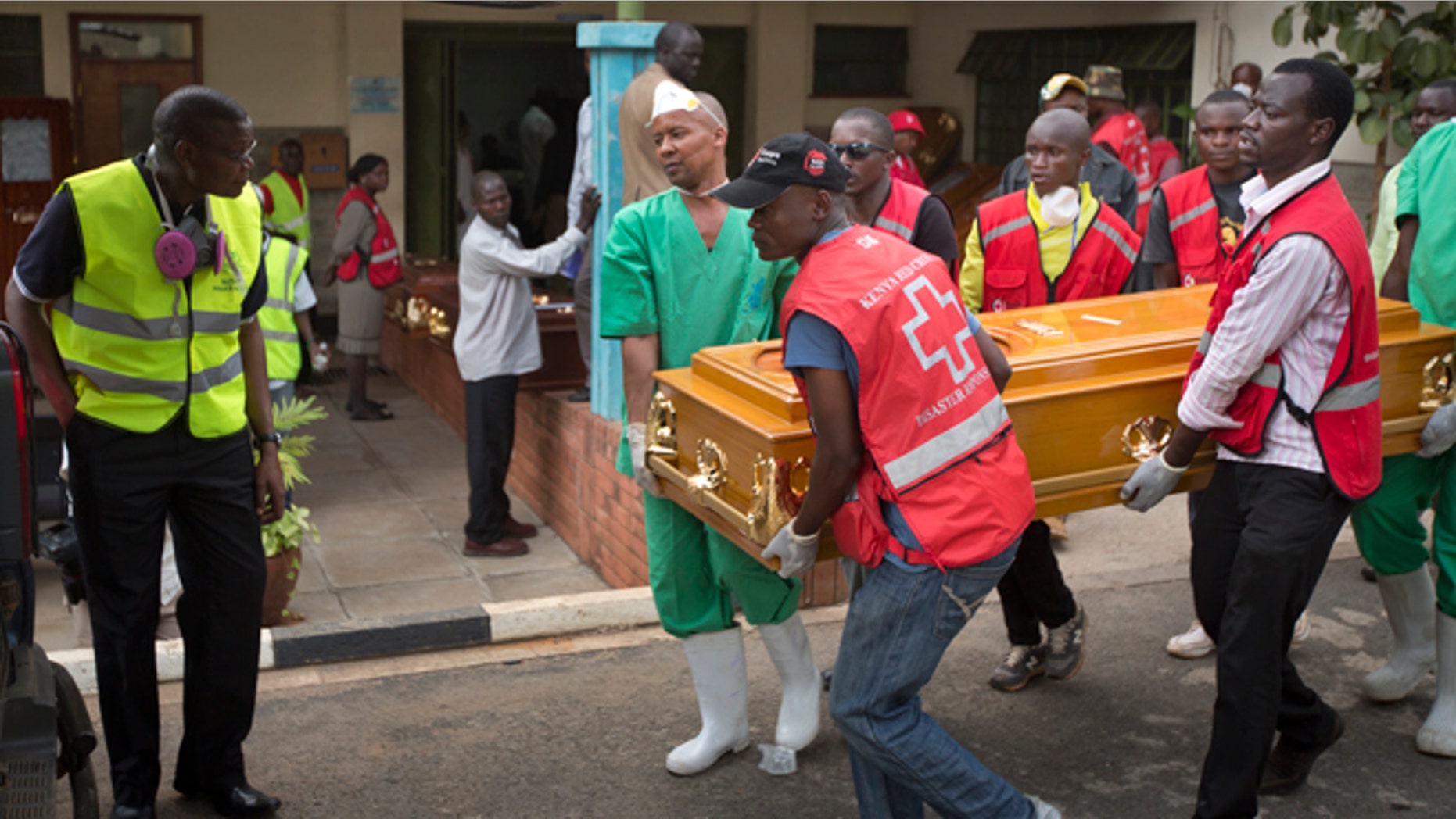 April 8, 2015: Morgue workers and Red Cross staff help to carry out the coffin of student Mildred Yondo, who was killed in last week's attack by extremist group Al-Shabasb at Garissa University, from the Chiromo Funeral Parlour in Nairobi, Kenya.