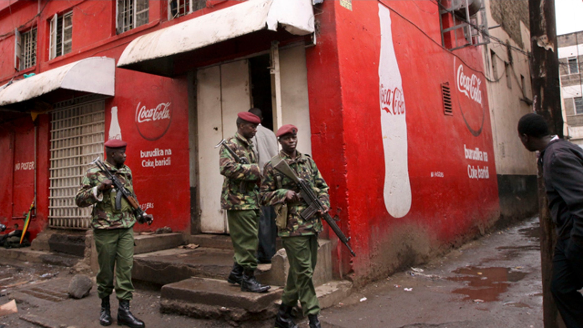 Oct. 24, 2011: Kenyan police patrol outside the pub that was the scene of a suspected grenade blast in downtown Nairobi, Kenya, which a police official said wounded over a dozen people.