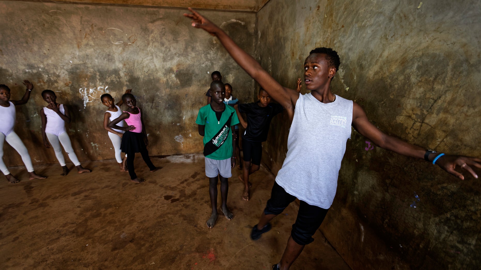 Young ballerinas receive instruction from Kenyan ballet dancer Joel Kioko, 16, in a room at a school in the Kibera slum of Nairobi, Kenya.