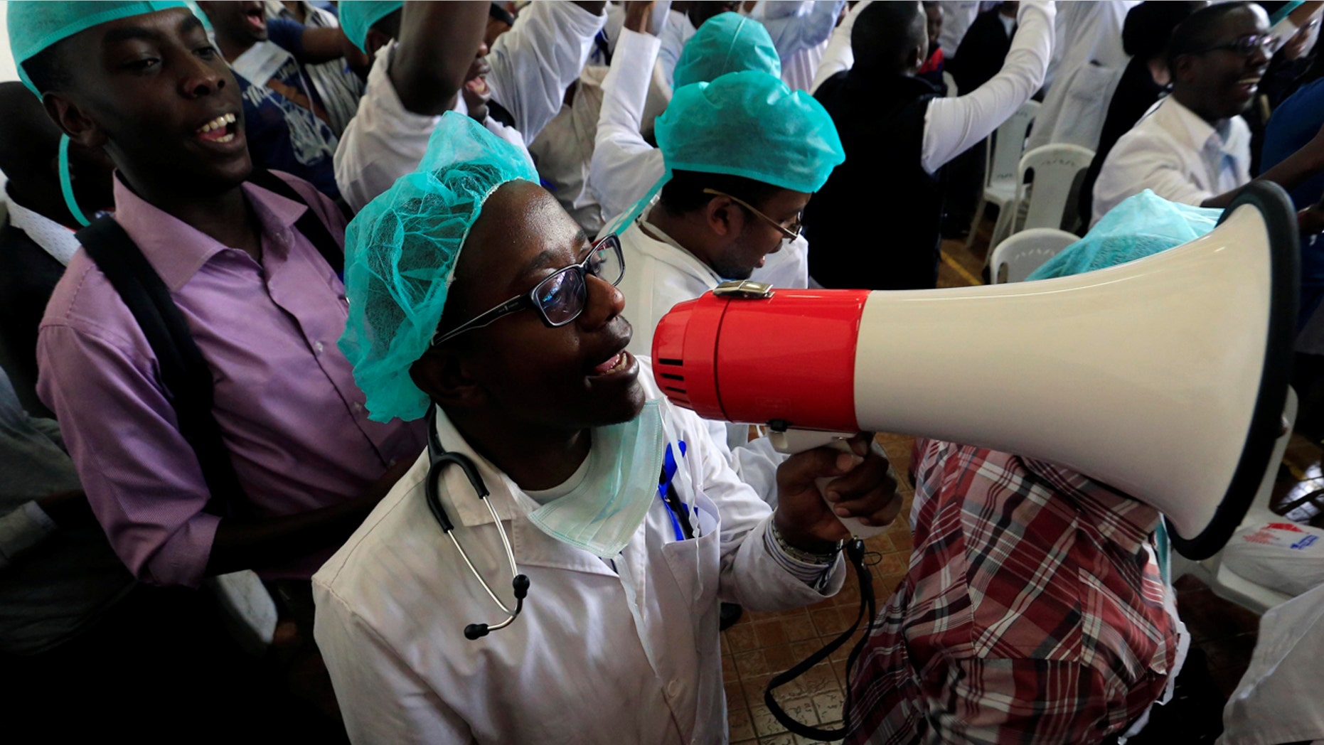 A Kenyan doctor uses a megaphone to shout a slogan to demand fulfilment of a 2013 agreement between their union and the government that would raise their pay and improve working conditions at a meeting in Nairobi, Kenya December 5, 2016.