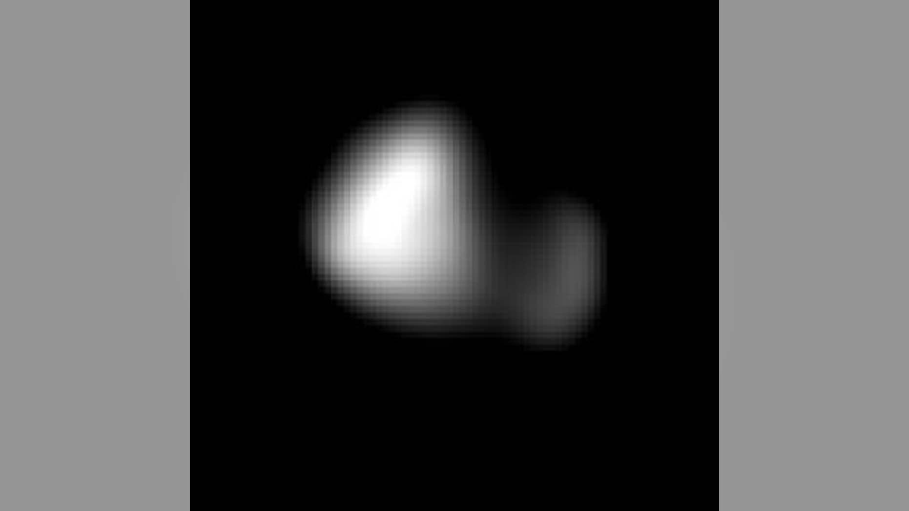 This image of Kerberos was created by combining four individual Long Range Reconnaissance Imager pictures taken on July 14, approximately seven hours before New Horizons’ closest approach to Pluto, at a range of 245,600 miles from Kerberos. Kerberos appears to have a double-lobed shape, approximately 7.4 miles across in its long dimension and 2.8 miles in its shortest dimension. (NASA/Johns Hopkins University Applied Physics Laboratory/Southwest Research Institute)