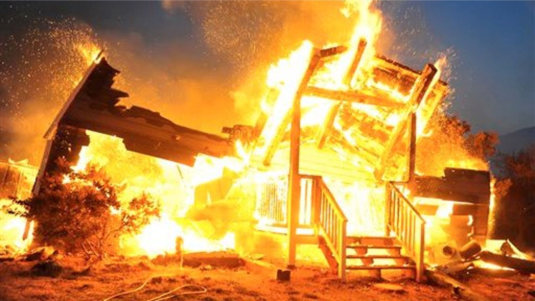 July 27: Two wildfires that erupted and spread quickly in Southern California have destroyed dozens of homes including this house about five miles above Highline Road in Tehachapi and forced evacuations in remote areas of the state's Kern County. More than 30 homes were lost in the small hill community of Old West Ranch and another 150 structures were threatened, firefighters said Tuesday. (AP)