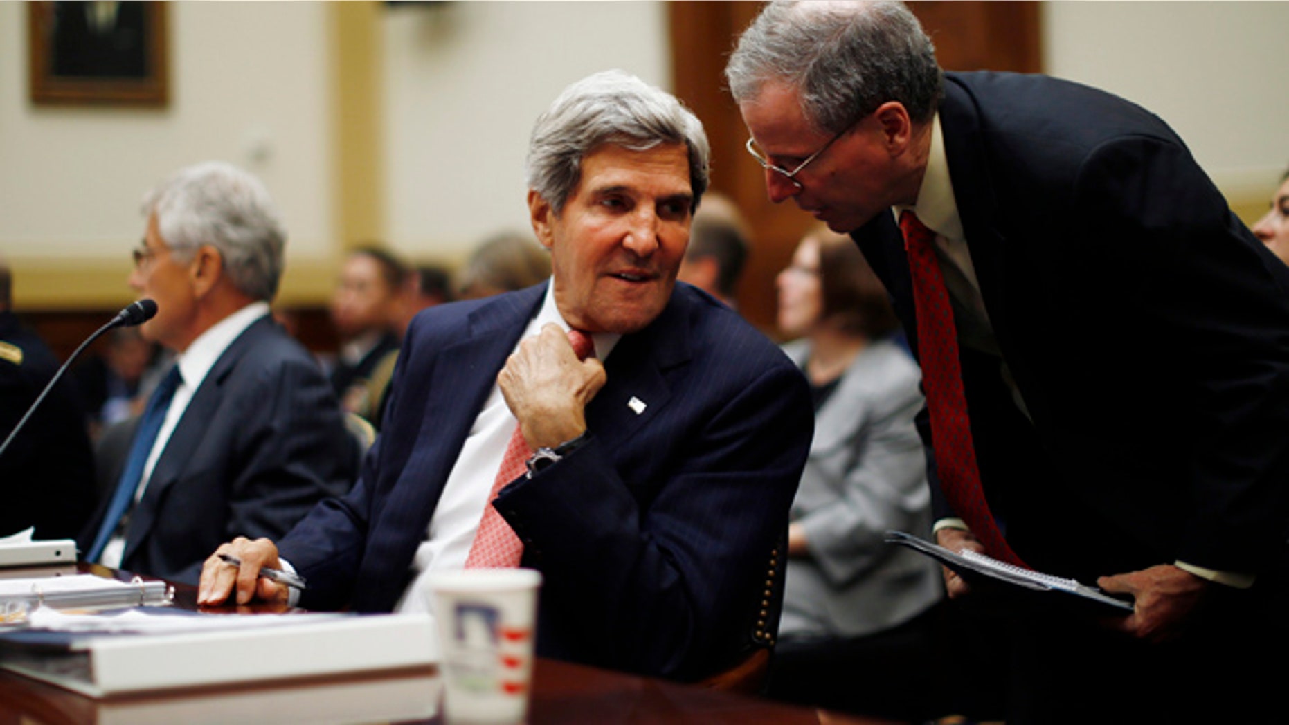 Sept. 4, 2013: Secretary of State John Kerry confers with U.S. Ambassador to Syria Robert Ford, right, as Kerry testifies at a House Foreign Affairs Committee hearing on Syria on Capitol Hill in Washington.