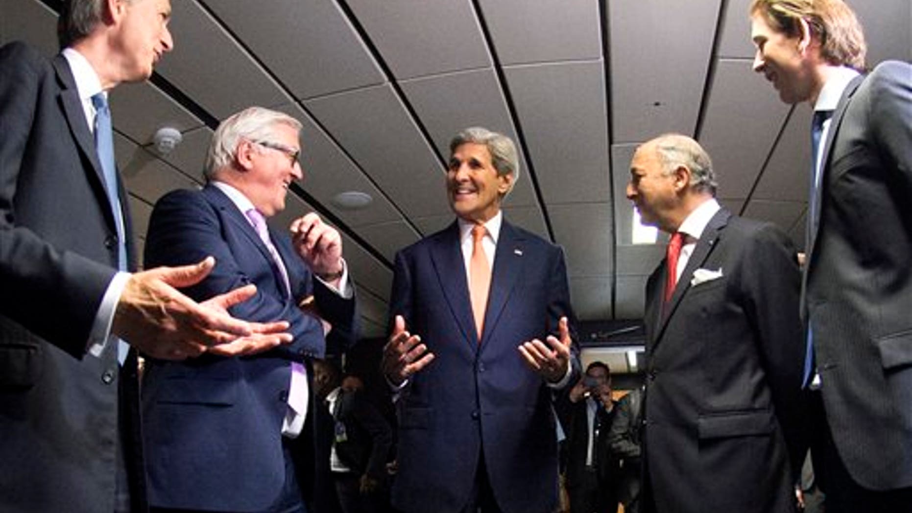 French Foreign Minister Laurent Fabius, second right, German Foreign Minister Frank-Walter Steinmeier, second left, British Foreign Secretary Philip Hammond, left, US Secretary of State John Kerry, center, and Austria's Foreign Minister Sebastian Kurz, right, talk prior to their final plenary meeting at the United Nations building in Vienna, Austria July 14, 2015. After 18 days of intense and often fractious negotiation, diplomats Tuesday declared that world powers and Iran had struck a landmark deal to curb Iran's nuclear program in exchange for billions of dollars in relief from international sanctions, an agreement designed to avert the threat of a nuclear-armed Iran and another U.S. military intervention in the Muslim world. (Joe Klamar/Pool Photo via AP)