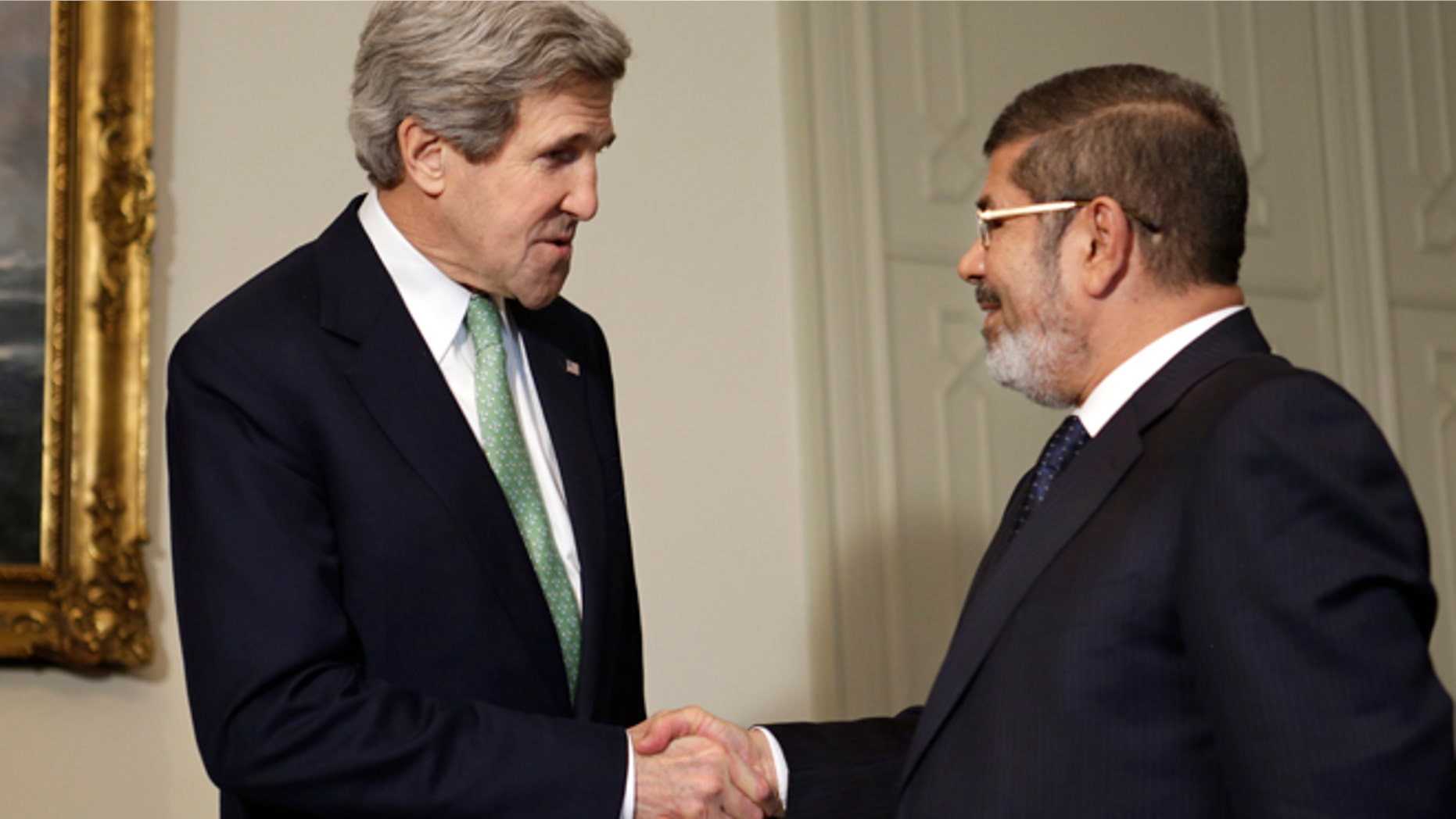 March 3, 2013: U.S. Secretary of State John Kerry, left, shakes hands with Egyptian President Mohamed Morsi at the Presidential Palace in Cairo, Egypt. U.S. Secretary of State John Kerry met with Egypt's president Sunday, wrapping up a visit to the deeply divided country with an appeal for unity and reform. The U.S. is deeply concerned that continued instability in Egypt will have broader consequences in a region already rocked by unrest.