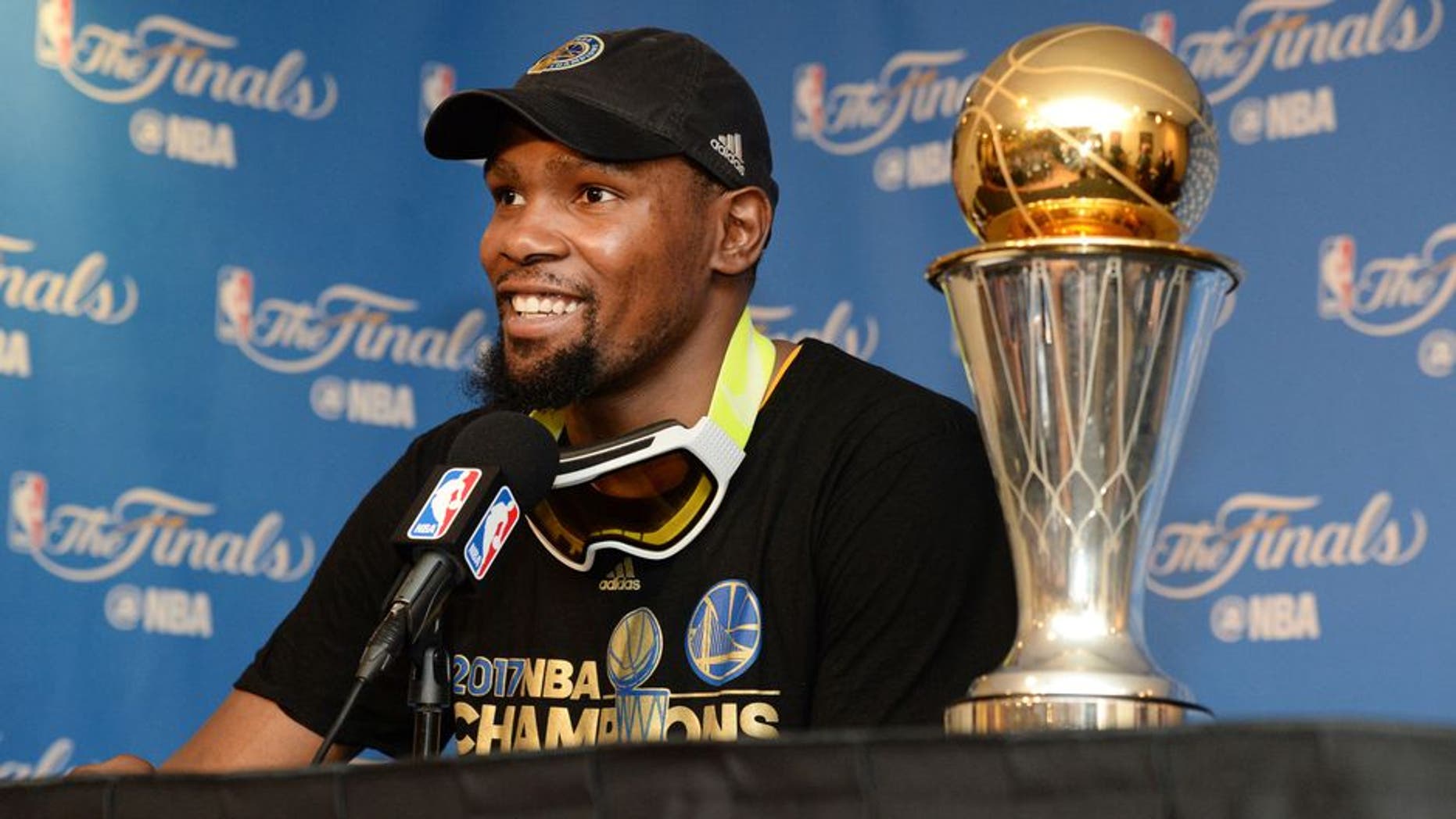 OAKLAND, CA - JUNE 12: NBA Finals MVP Kevin Durant #35 of the Golden State Warriors speaks to the media after winning the NBA Championship in Game Five of the 2017 NBA Finals against the Cleveland Cavaliers on June 12, 2017 at ORACLE Arena in Oakland, California. NOTE TO USER: User expressly acknowledges and agrees that, by downloading and/or using this photograph, user is consenting to the terms and conditions of Getty Images License Agreement. Mandatory Copyright Notice: Copyright 2017 NBAE (Photo by Andrew D. Bernstein/NBAE via Getty Images)