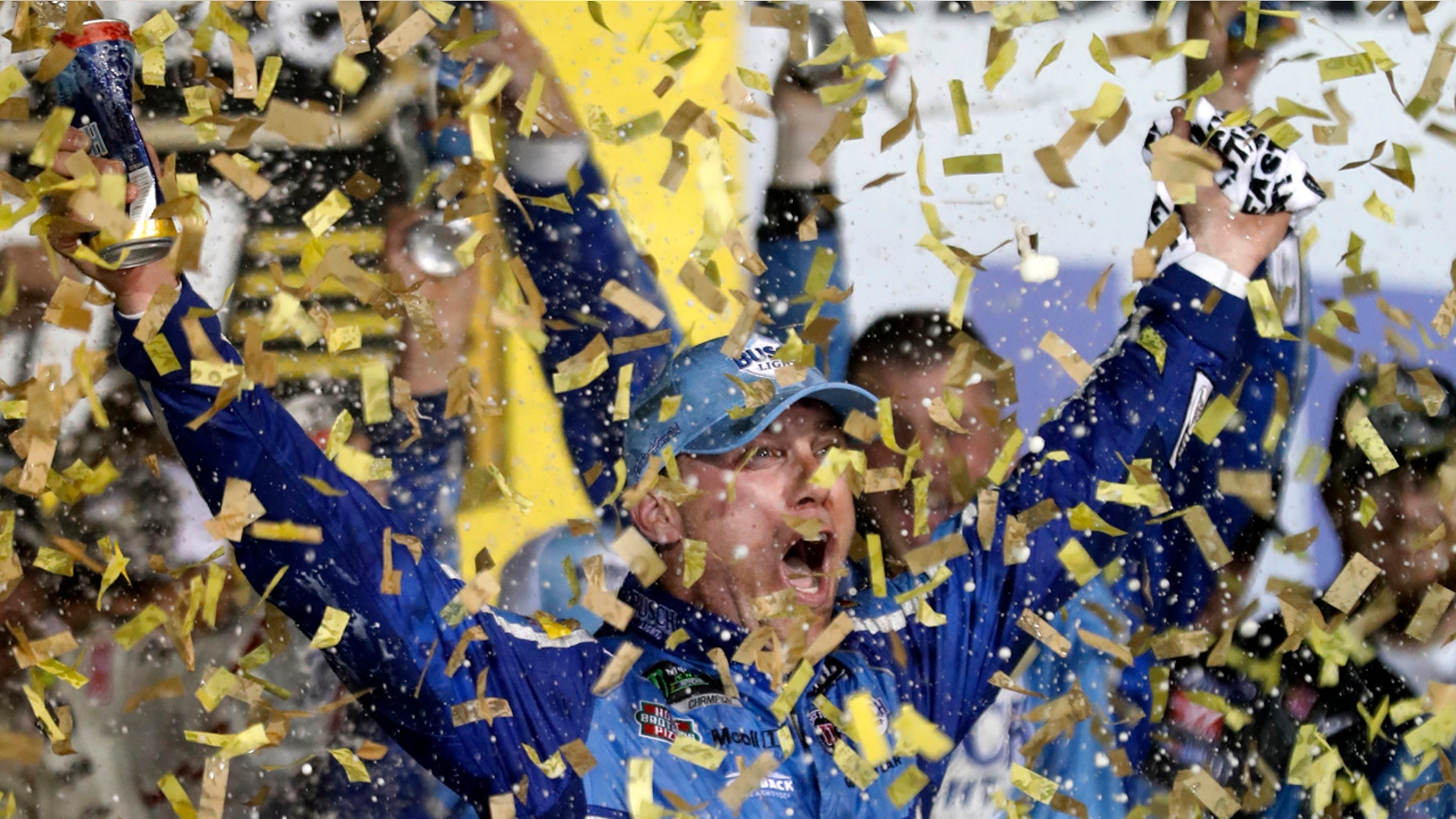 Kevin Harvick is covered in confetti as he celebrates winning the NASCAR Cup Series auto race at Kansas Speedway in Kansas City, Kan., Saturday, May 12, 2018. (AP Photo/Colin E. Braley)