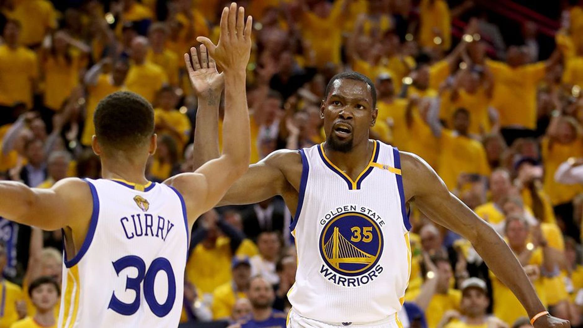 OAKLAND, CA - JUNE 04: Stephen Curry #30 and Kevin Durant #35 of the Golden State Warriors react to a play against the Cleveland Cavaliers in Game 2 of the 2017 NBA Finals at ORACLE Arena on June 4, 2017 in Oakland, California. NOTE TO USER: User expressly acknowledges and agrees that, by downloading and or using this photograph, User is consenting to the terms and conditions of the Getty Images License Agreement. (Photo by Ezra Shaw/Getty Images)