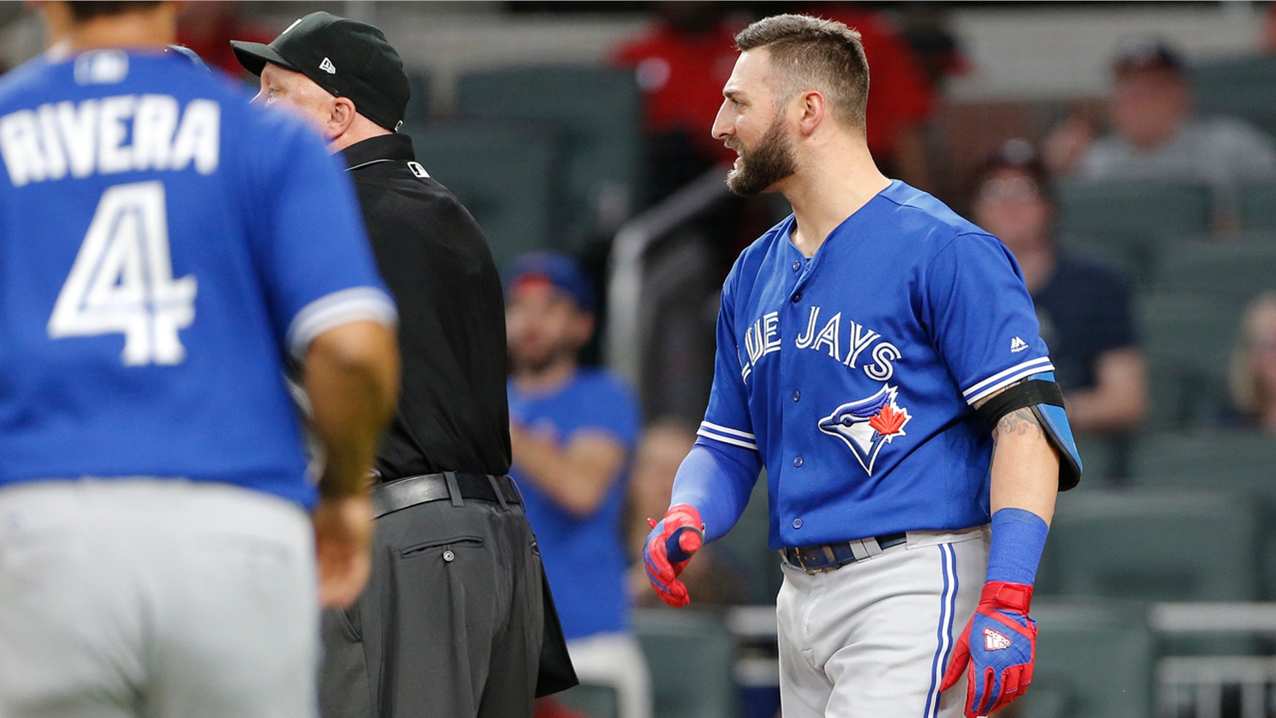 In this photo taken Wednesday, May, 17, 2017, Toronto Blue Jays Kevin Pillar (11) looks on as both benches empty onto the field after he exchanged words with Atlanta Braves relief pitcher Jason Motte (30) in the seventh inning of a baseball game , in Atlanta. Pillar has been suspended two games for yelling an anti-gay slur at a Braves pitcher. (AP Photo/John Bazemore)