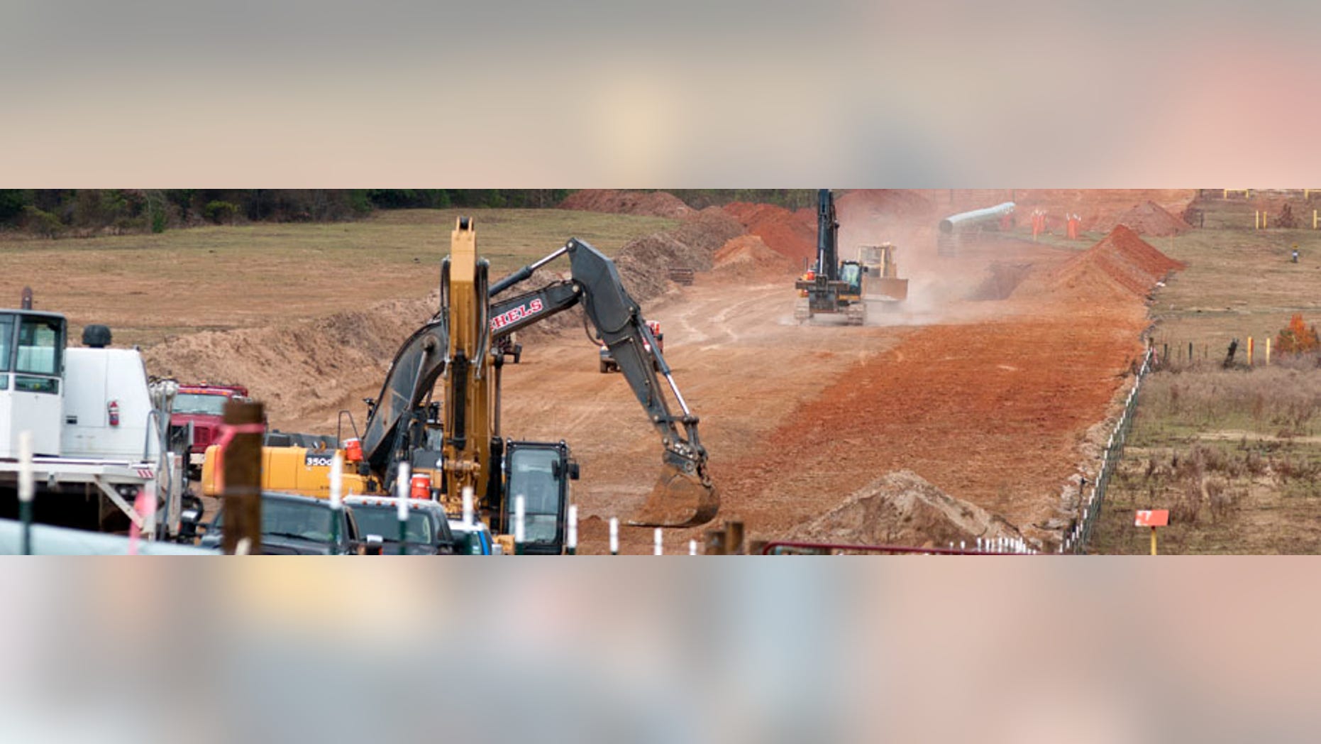 FILE - In this Dec. 3, 2012 file photo, crews work on construction of the TransCanada Keystone XL Pipeline near County Road 363 and County Road 357, east of Winona, Texas. In a move that disappointed environmental groups and cheered the oil industry, the Obama administration on Jan. 31, 2014, said it had no major environmental objections to the proposed Keystone XL oil pipeline from Canada. (AP Photo/The Tyler Morning Telegraph, Sarah A. Miller)
