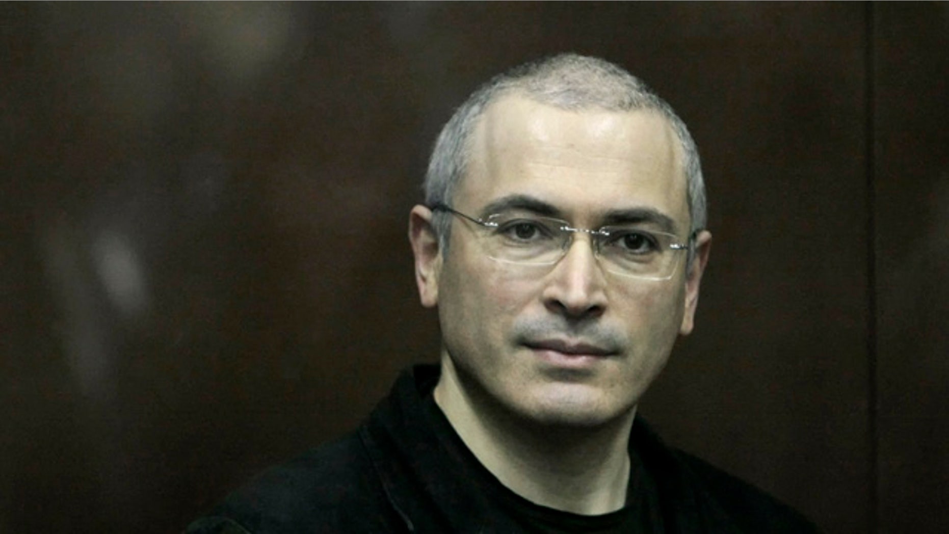 Dec. 30: Mikhail Khodorkovsky, 47, looks on from behind a glass enclosure at a court room in Moscow. (AP)
