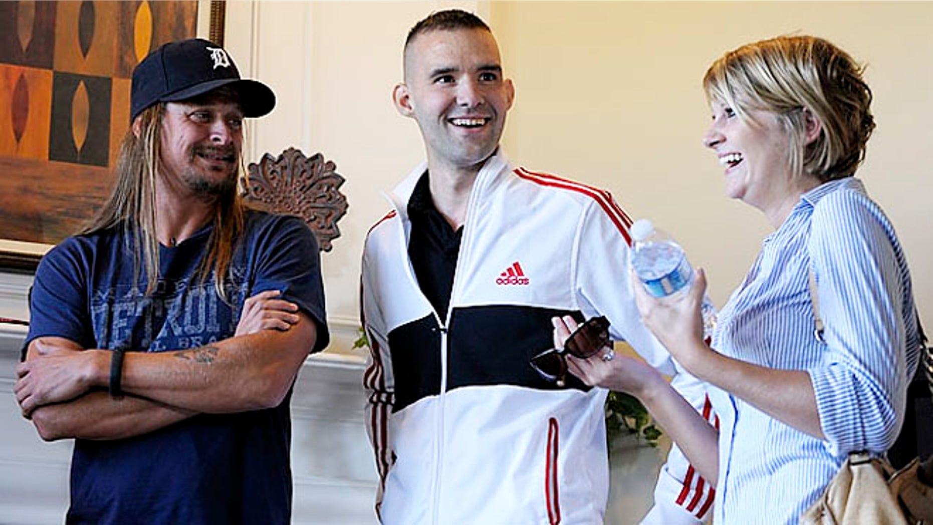 Musician Kid Rock, left, with Sgt. Davin Dumar and his wife, Dana.