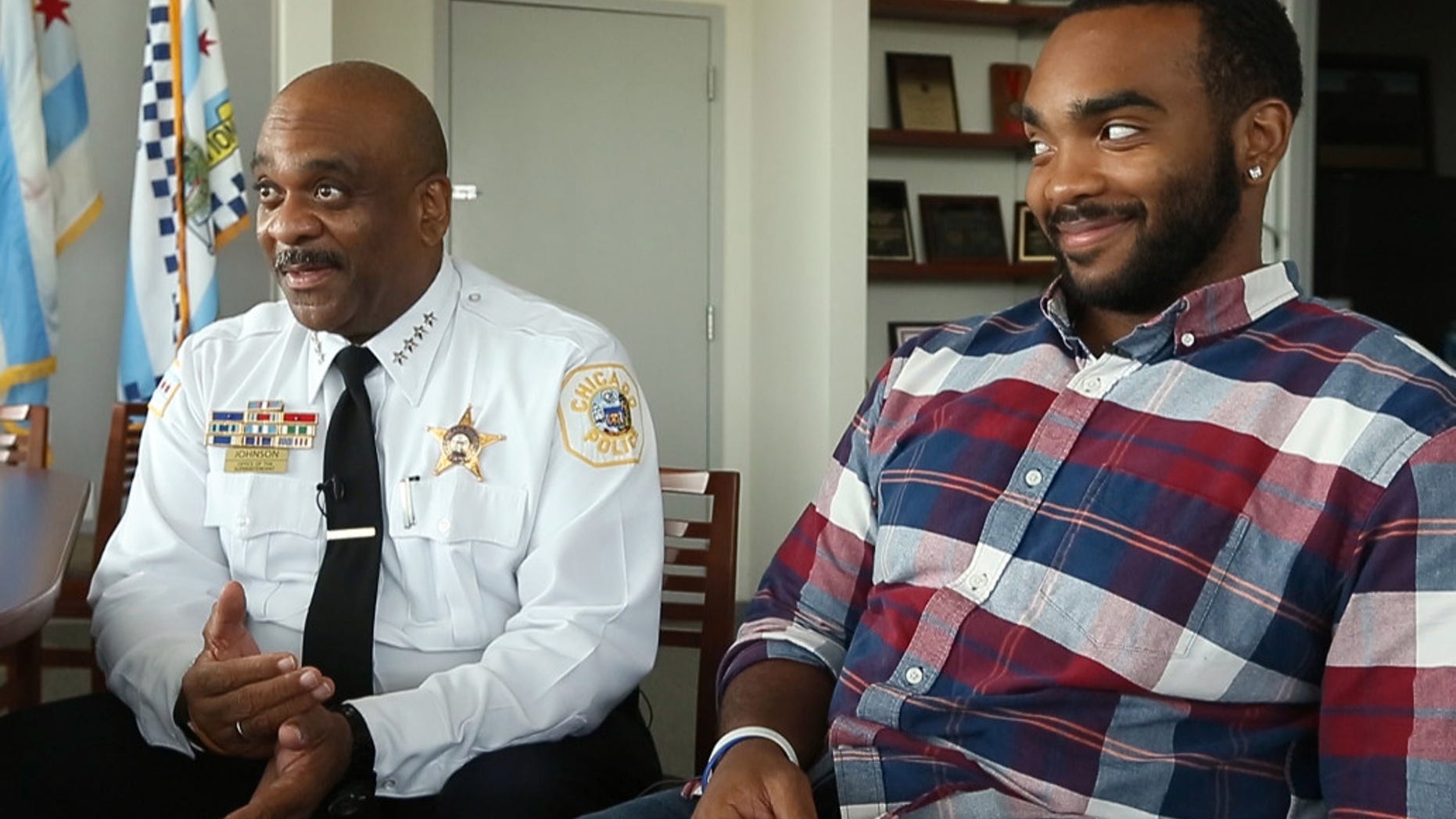 The Chicago Sun-Times says Daniel Johnson got a big hug from his new boss, police Superintendent Eddie Johnson, when he crossed the stage Tuesday.