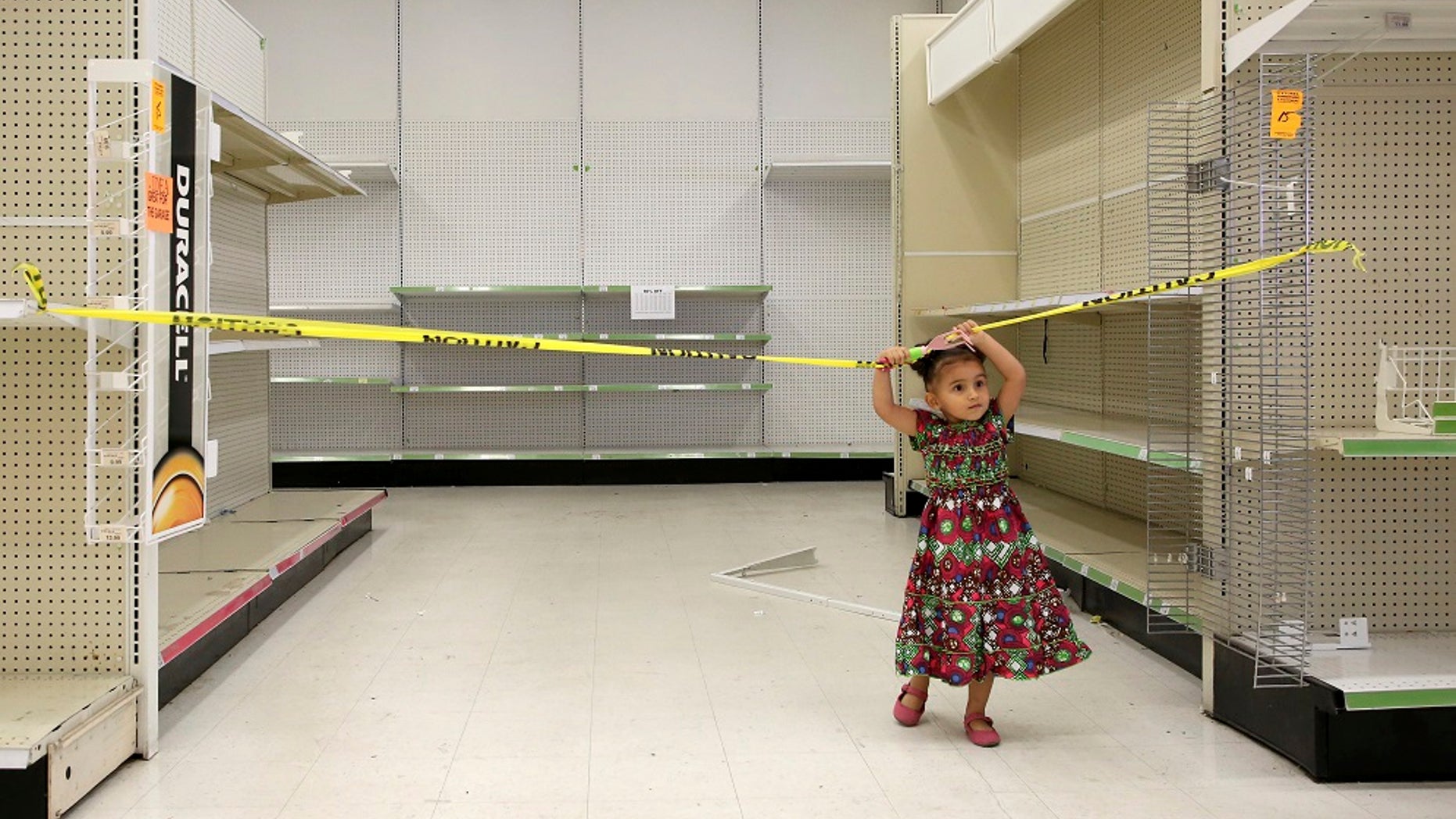 A young plays in an empty isle of a Toys R Us store in Houston on Thursday, June 28, 2018.