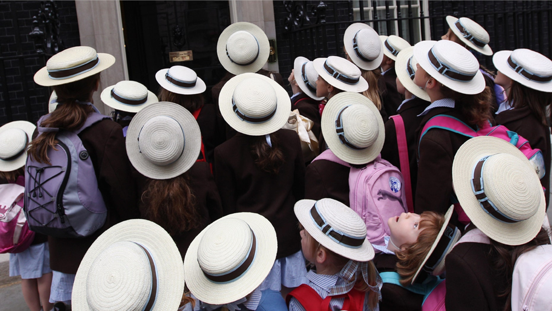 LONDON, ENGLAND - JULY 13: Schoolchildren from St Hilda's Junior School stand outside the entrance to Number 10 while visiting Downing Street on July 13, 2010 in London, England. (Photo by Dan Kitwood/Getty Images)