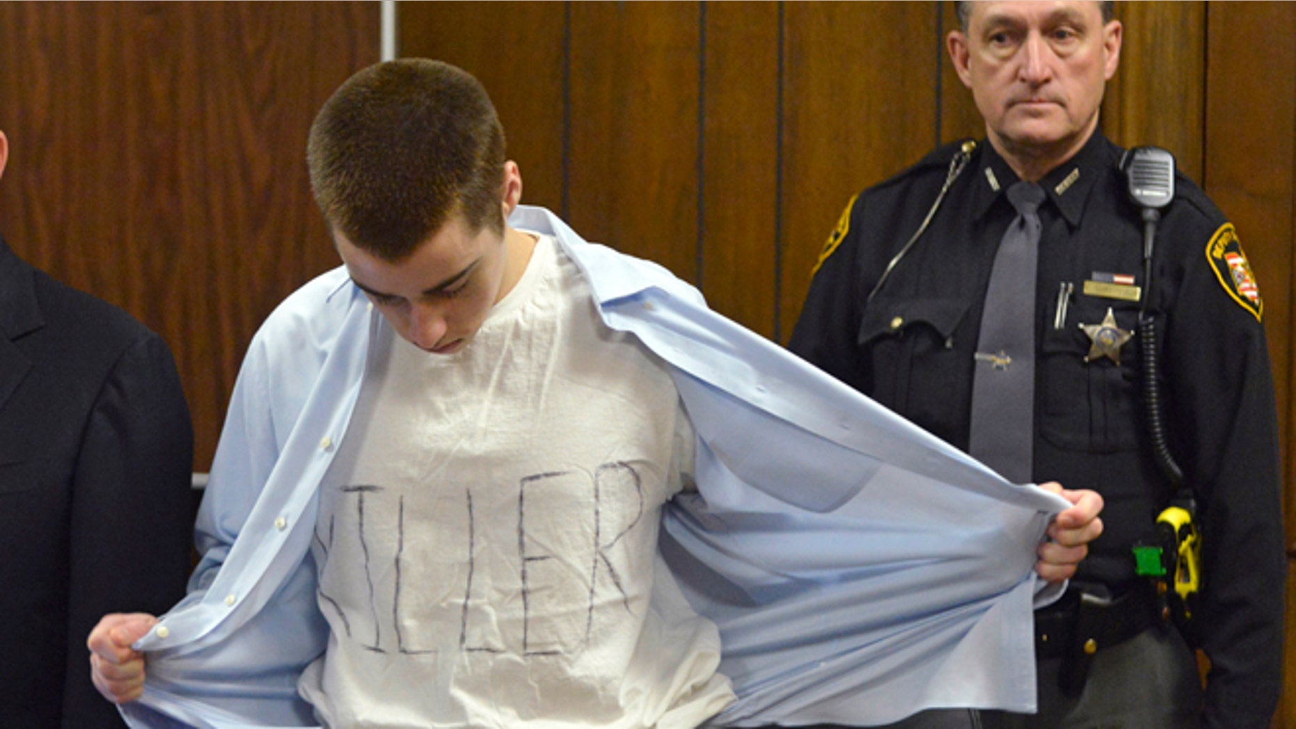 March 19: T.J. Lane unbuttons his shirt during sentencing Tuesday, March 19, 2013, in Chardon, Ohio.