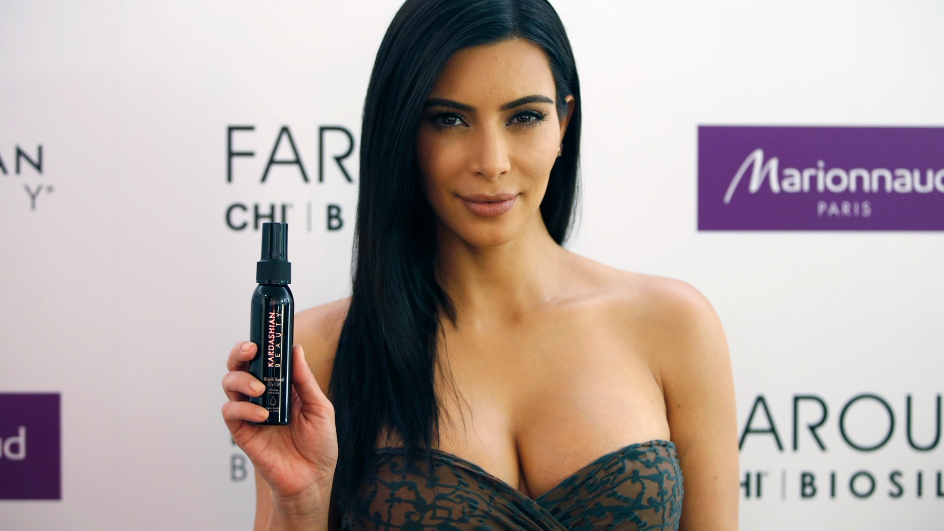 April 15, 2015. TV star Kim Kardashian poses as she presents her Kardashian Beauty Hair collection for Marionnaud at the flagship store on the Champs-Elysees in Paris.