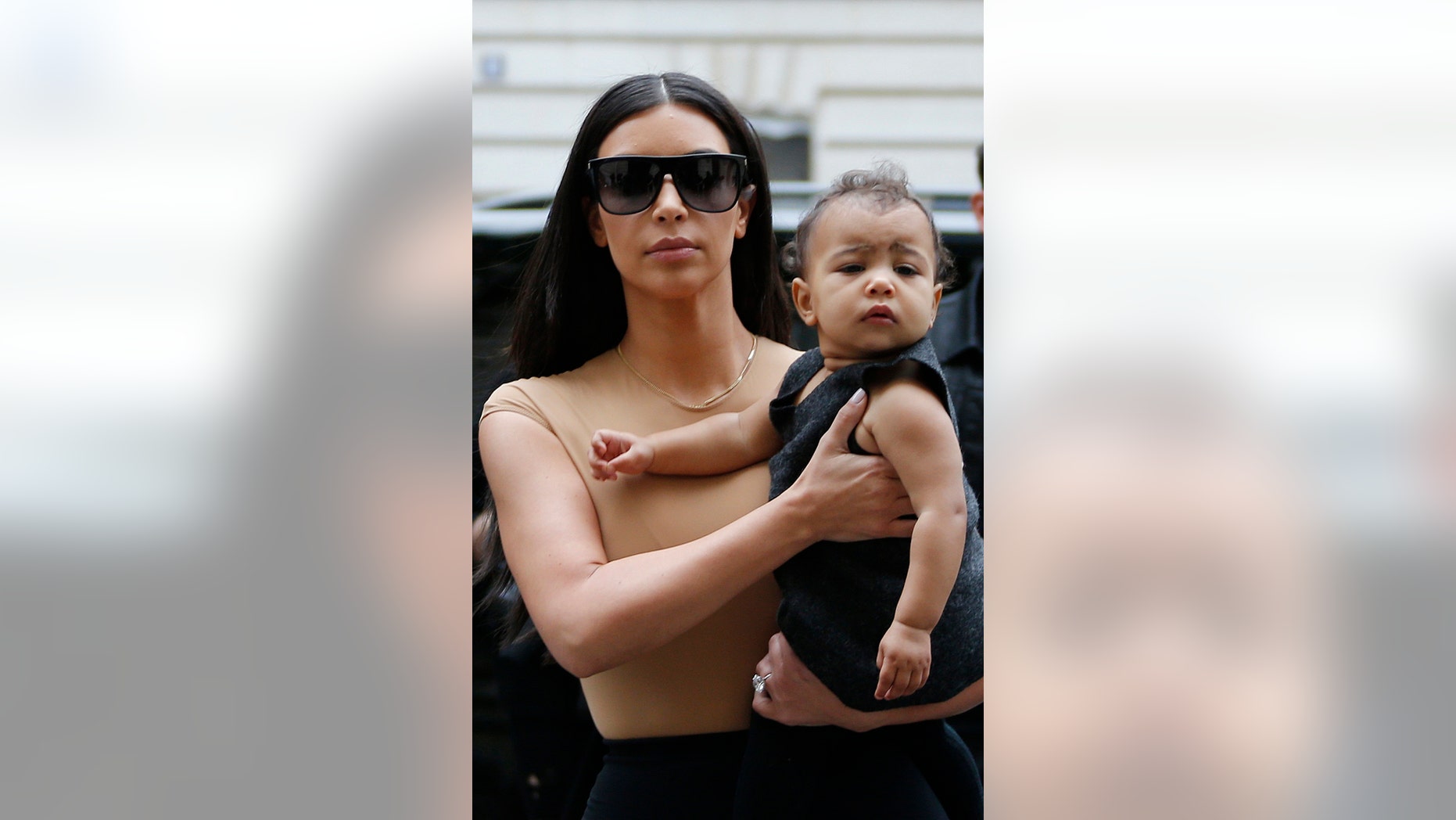 May 20, 2014. TV personality Kim Kardashian holds her daughter North, in her arms as she shops in Paris.